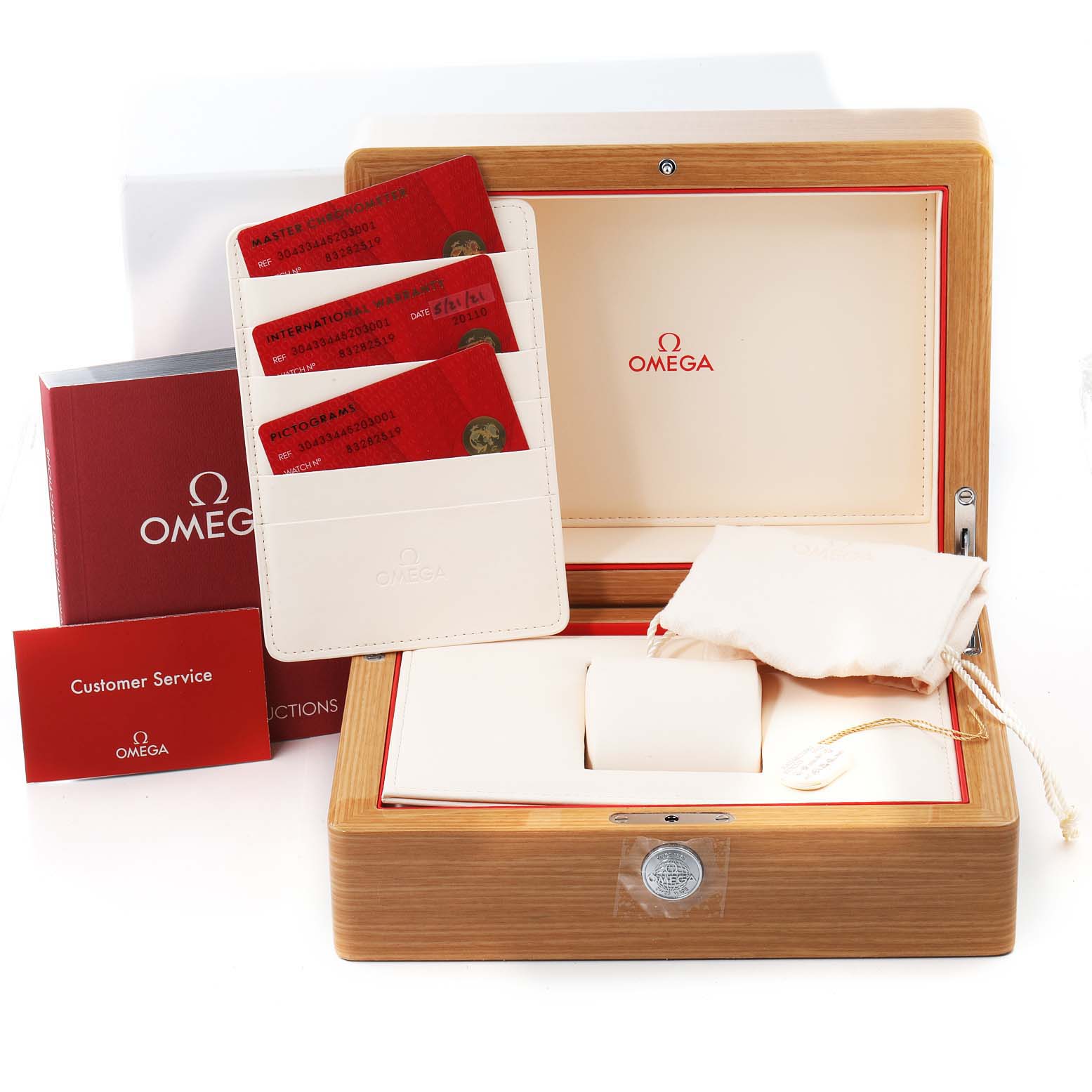 The image shows an open Omega Speedmaster 304.33.44.52.03.001 Men's Stainless Steel Blue Dial 304.33.44.52.03.001 Men's Stainless Steel Blue Dial watch box from an upper front angle, with various accessories including cards, booklets, and pouches.