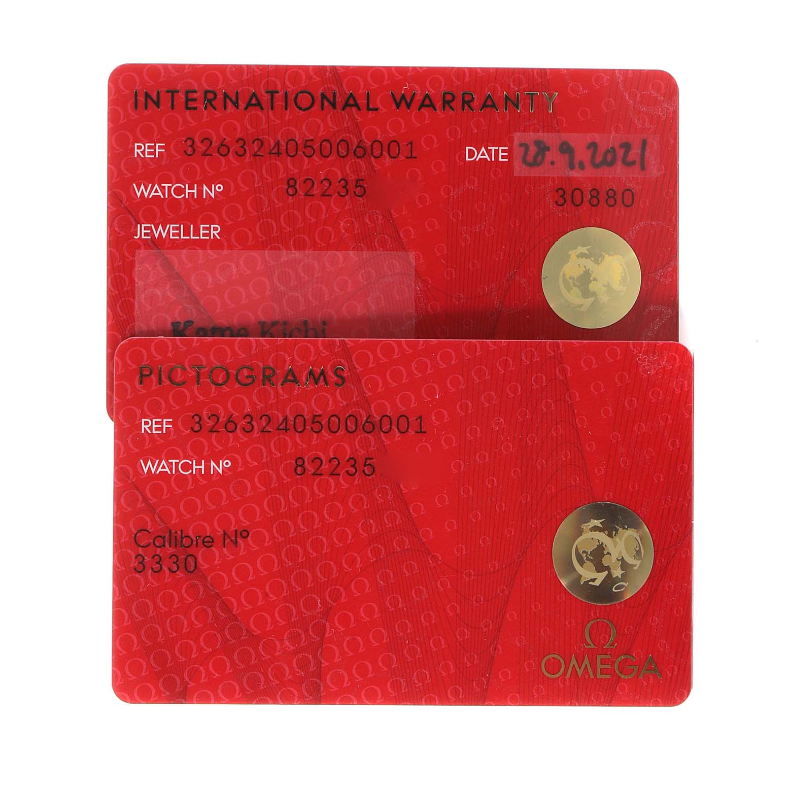 The image shows two red identification cards for the Omega Speedmaster 326.32.40.50.06.001 Men
s Stainless Steel Grey Dial 326.32.40.50.06.001 Men
s Stainless Steel Grey Dial watch, displaying warranty and pictogram information.