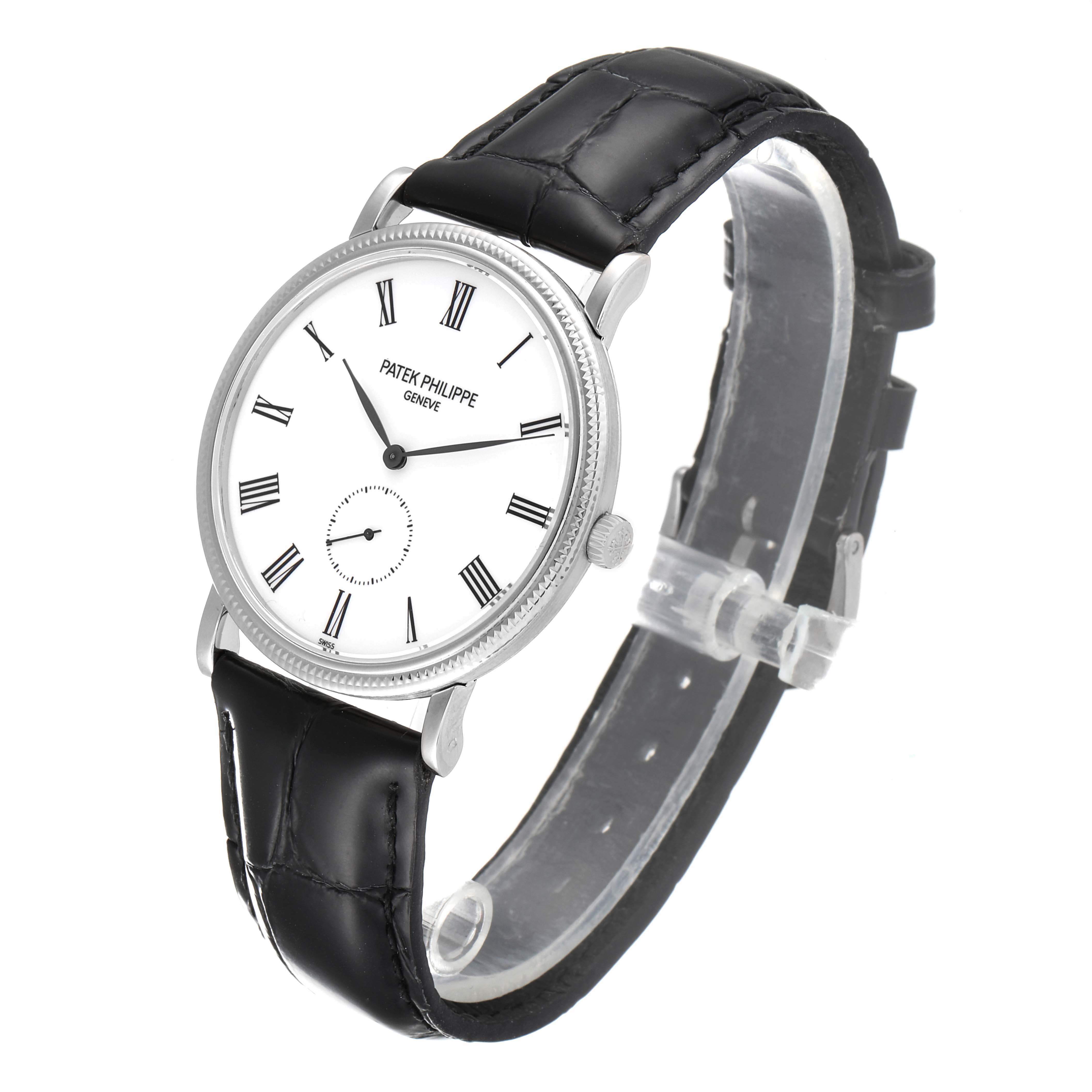 The image shows a side-front angled view of a Patek Philippe Calatrava 5119G Men
s White Gold White Dial 5119G Men
s White Gold White Dial watch with a black leather strap and white dial with Roman numerals.