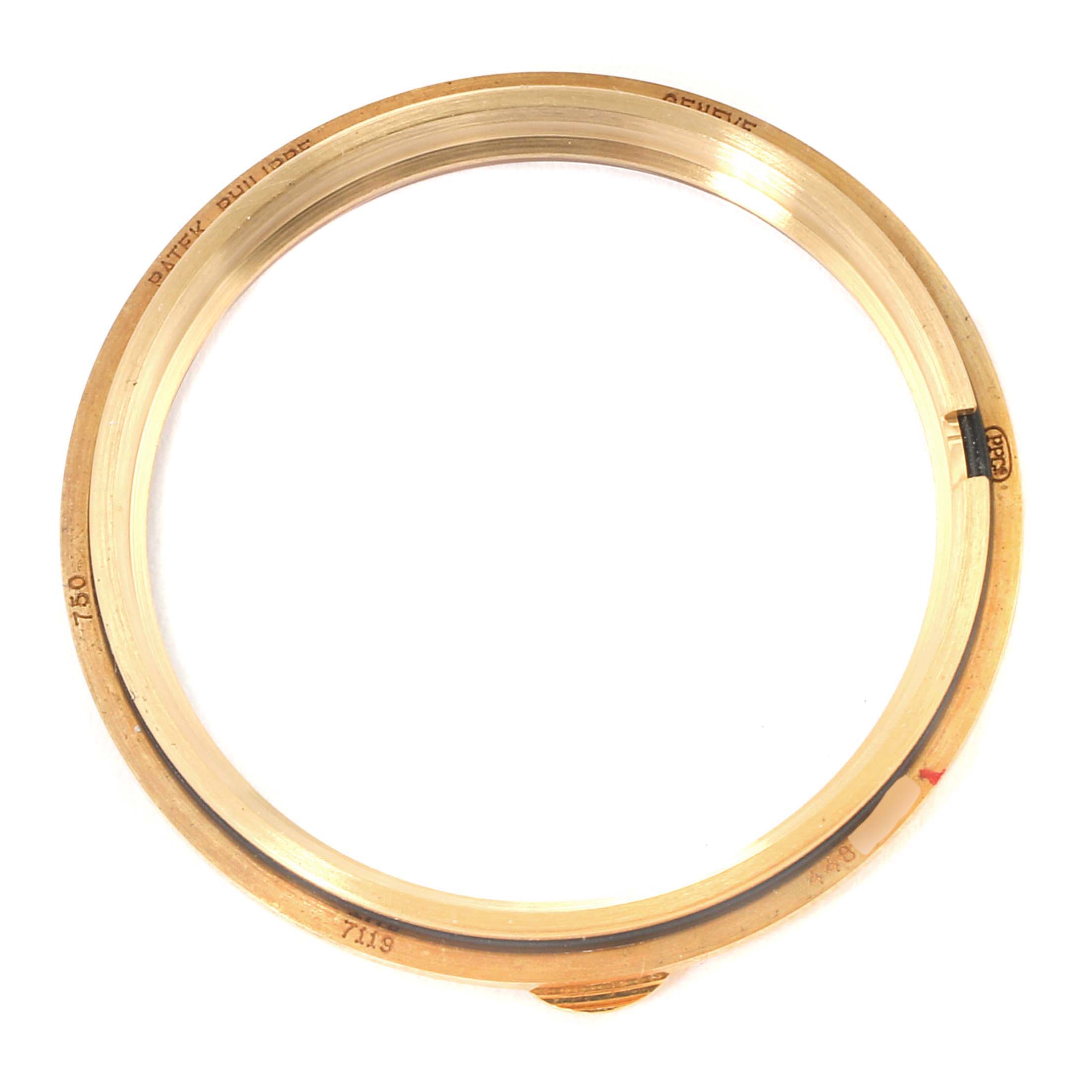 This image shows the bezel of a Patek Philippe Calatrava 7119J Women's Yellow Gold White Dial 7119J Women's Yellow Gold White Dial watch from a top-down angle.