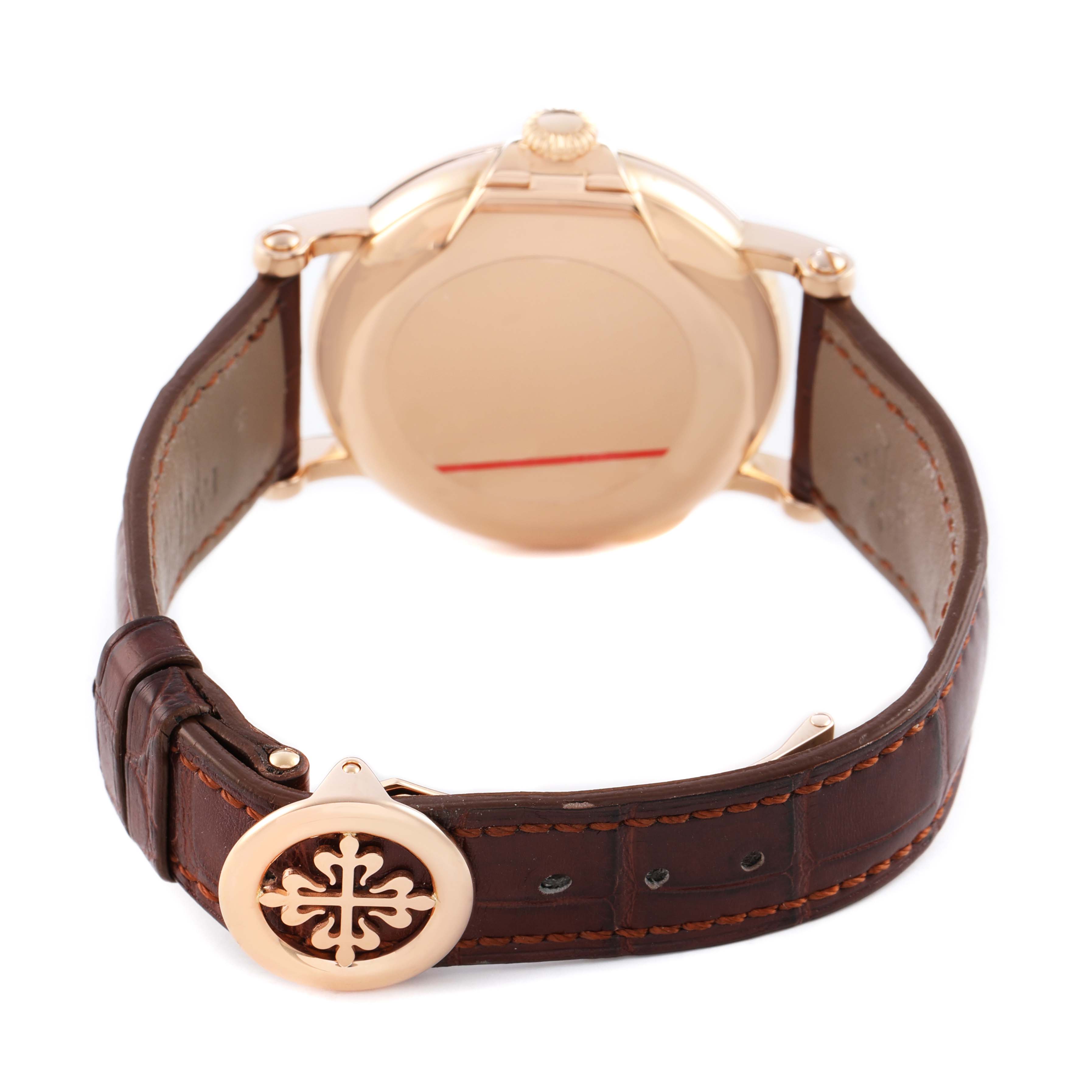 The image shows the back of a Patek Philippe Calatrava 5153 5153R Men's Rose Gold Silver Dial watch with a brown leather strap and the clasp prominently displayed.