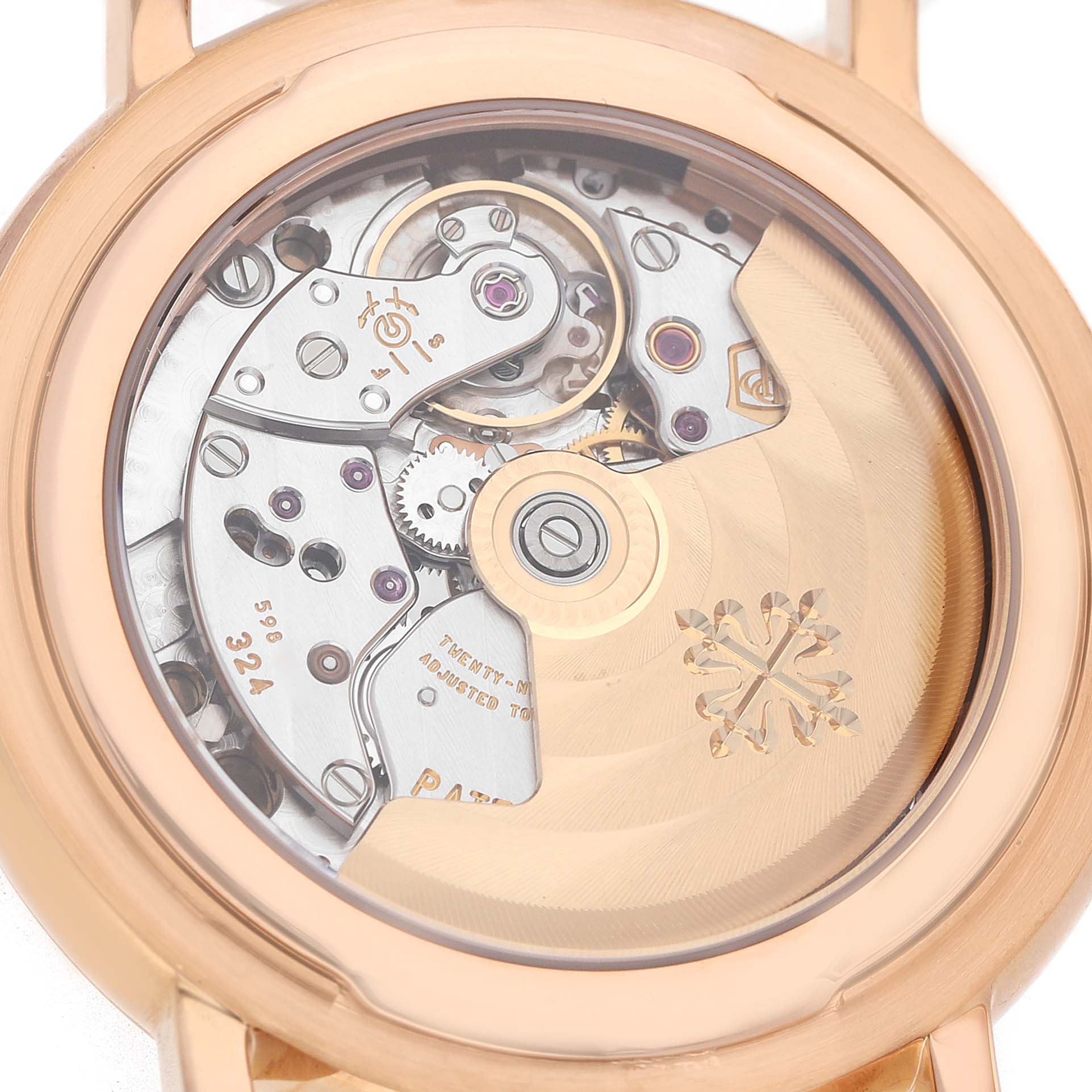The image shows the back view of a Patek Philippe Calatrava 5153 5153R Men's Rose Gold Silver Dial watch, highlighting its intricate movement and rotor.