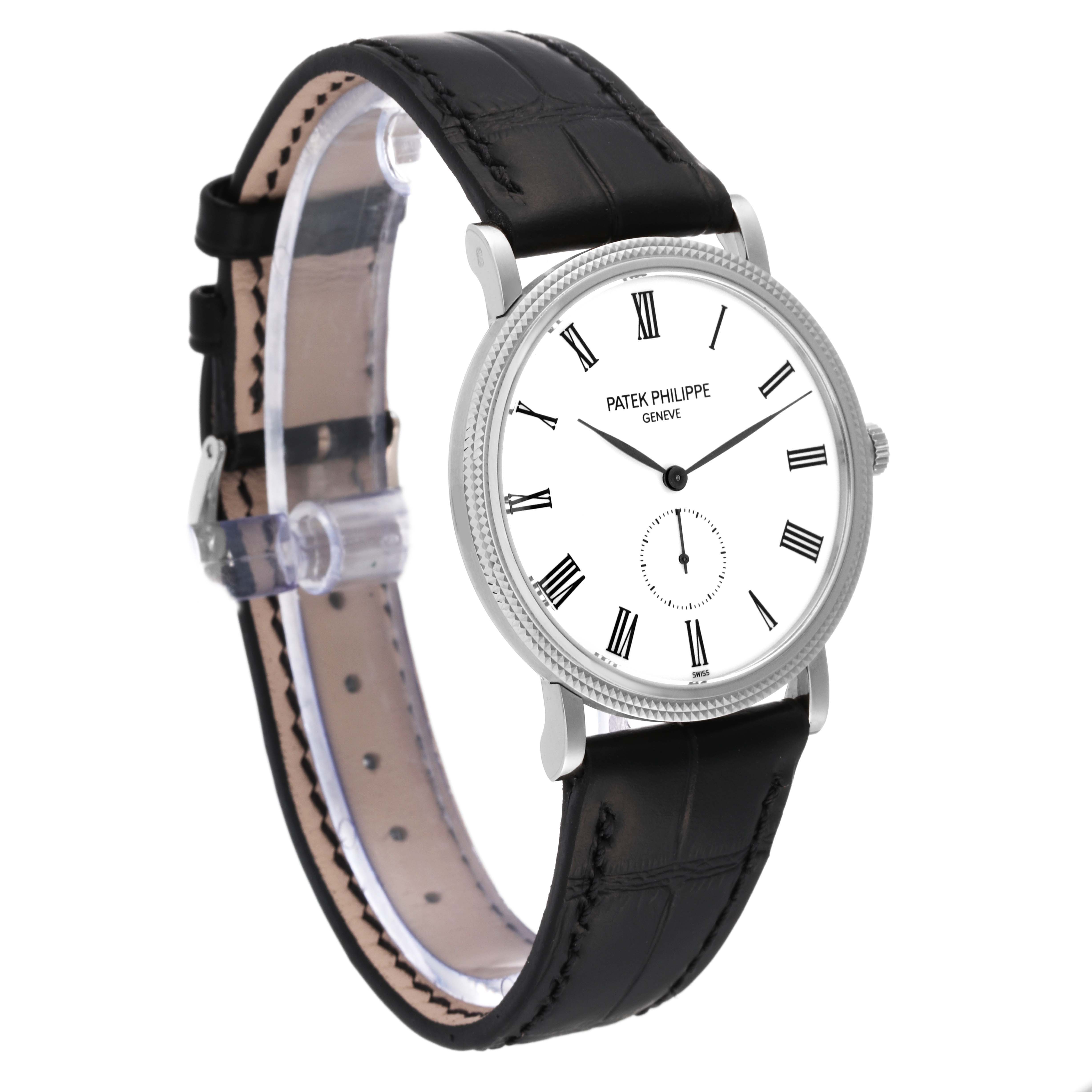 The Calatrava model by Patek Philippe is shown at a front-side angle displaying its white dial, black leather strap, and Roman numeral markers.