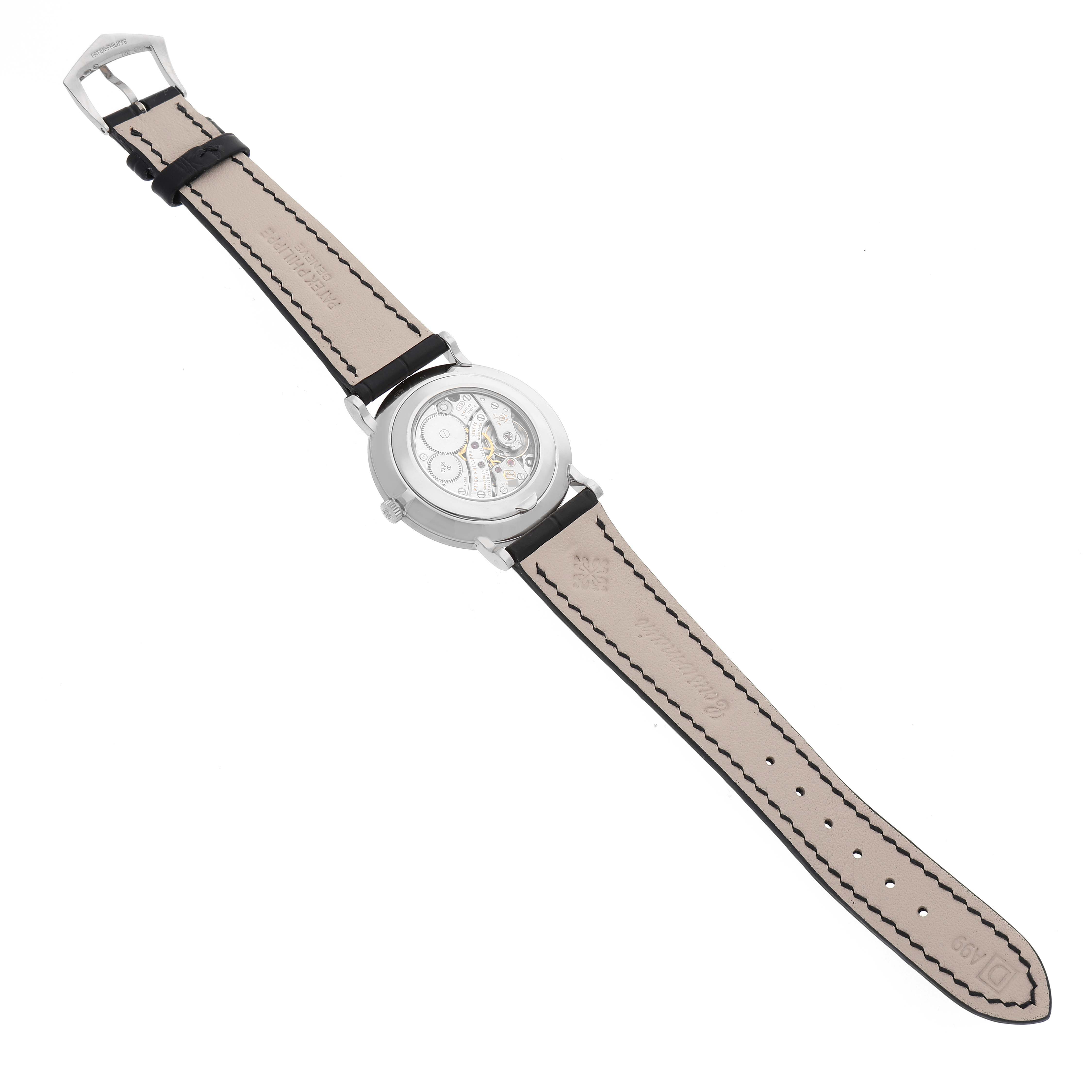 The image displays the back view of a Patek Philippe Calatrava 5119G Men
s White Gold White Dial 5119G Men
s White Gold White Dial watch, showcasing its leather strap and visible mechanical movement.