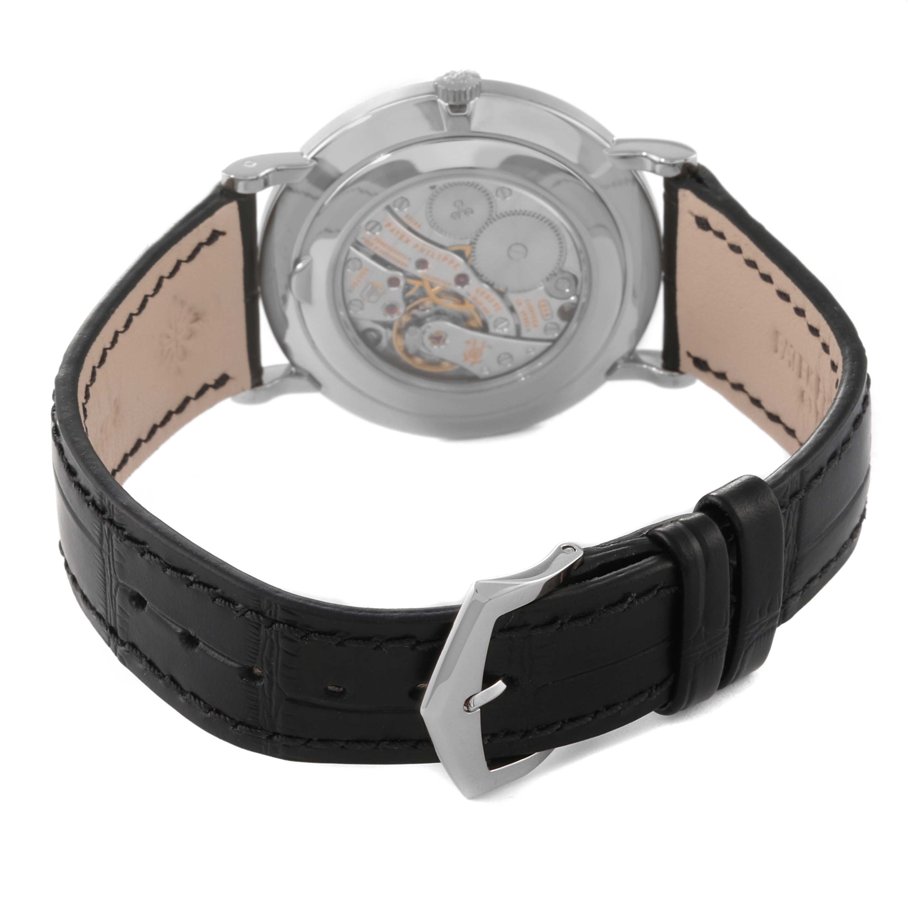 The image shows a rear view of the Patek Philippe Calatrava 5119G Men
s White Gold White Dial 5119G Men
s White Gold White Dial watch, displaying its movement and black leather strap.