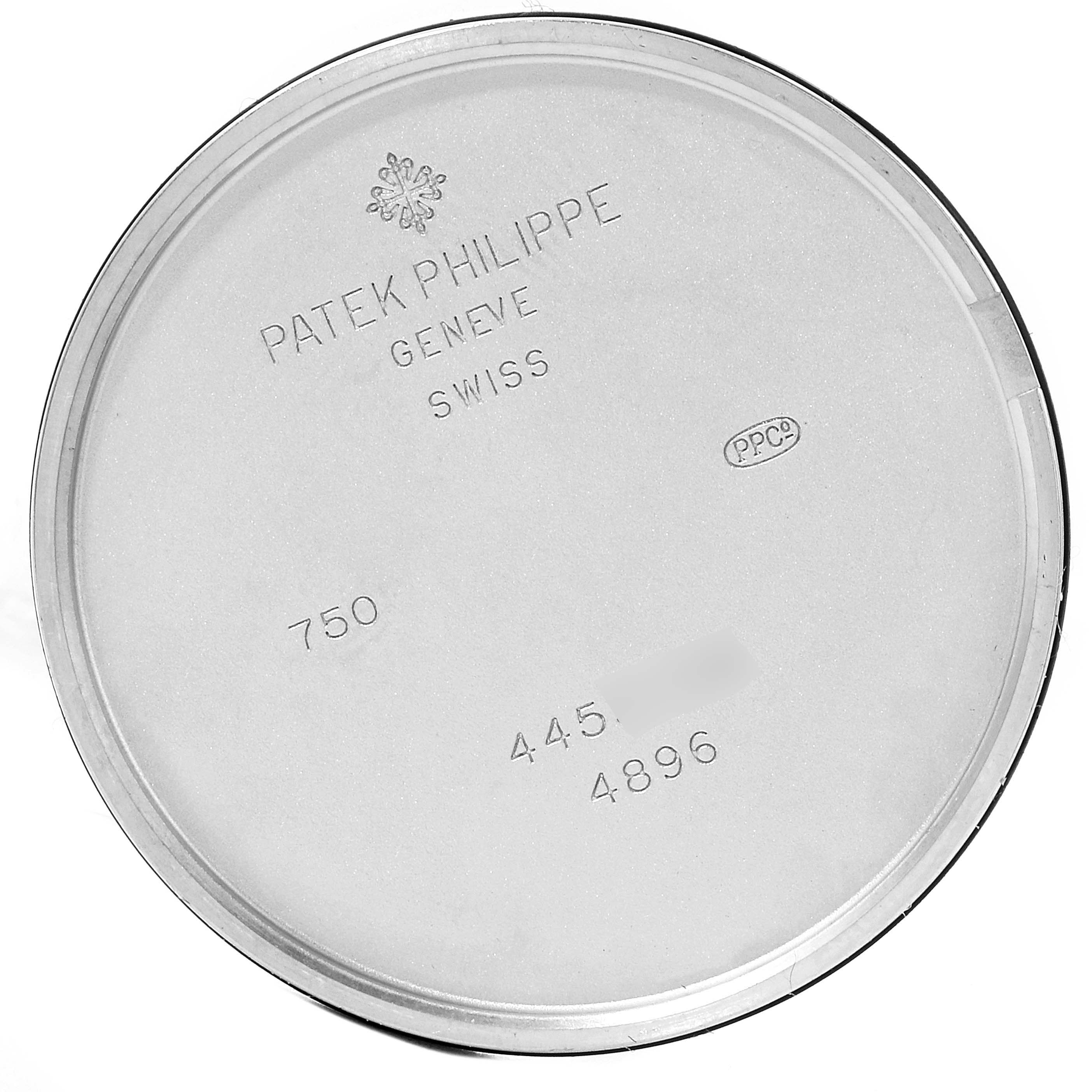 The image shows the inside case back of a Patek Philippe Calatrava 4896G Men's White Gold Blue Dial 4896G Men's White Gold Blue Dial watch, featuring engraved model and brand information.