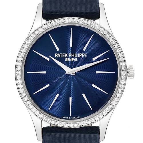 The image shows a front view of the Patek Philippe Calatrava watch, highlighting its blue dial, diamond bezel, and silver indices.