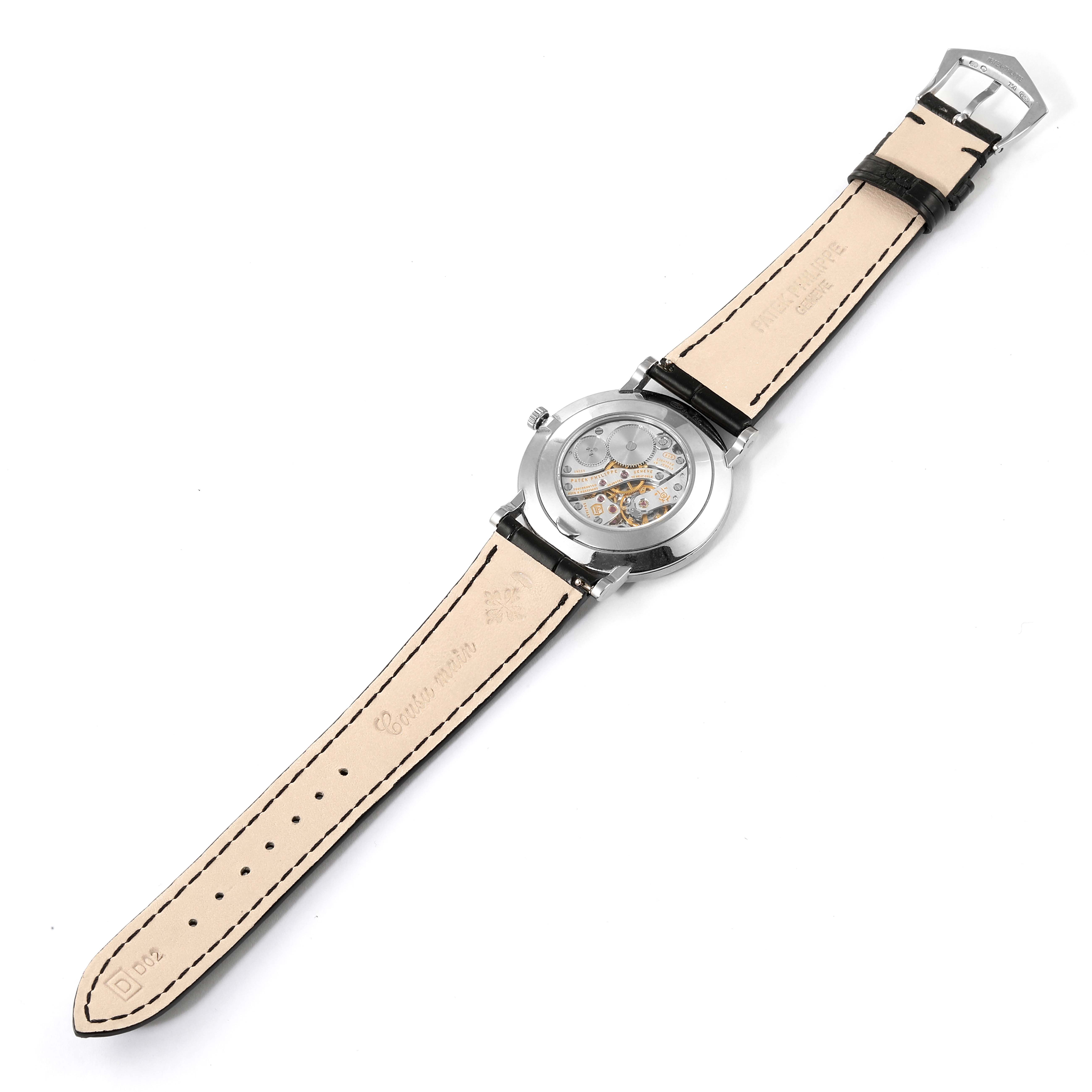 The image shows the back view of the Patek Philippe Calatrava 5116G Men
s White Gold White Dial 5116G Men
s White Gold White Dial watch, highlighting the transparent case back and the strap.