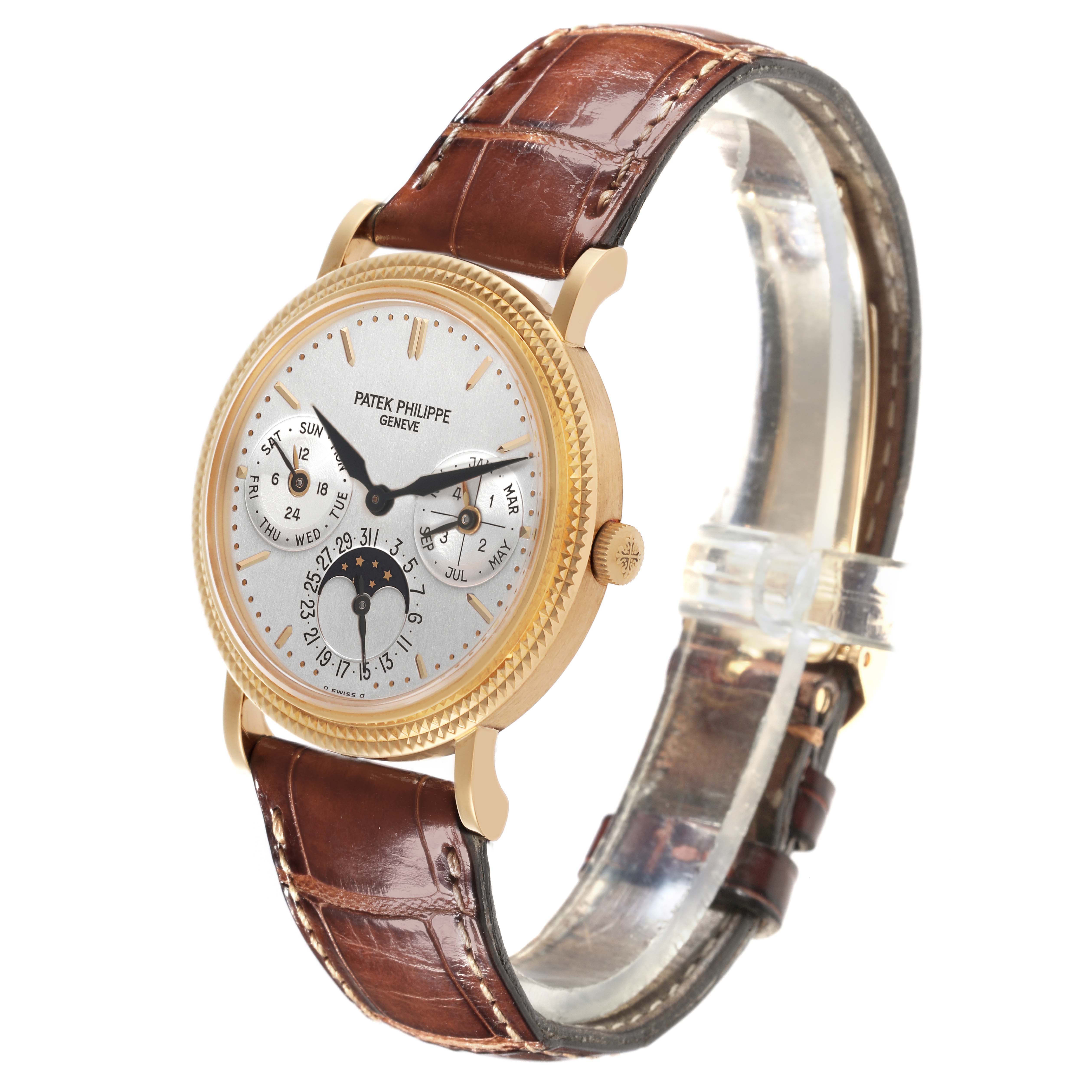 The Patek Philippe Complications 5039J-001 Men's Yellow Gold Silver Dial 5039J-001 Men's Yellow Gold Silver Dial watch is shown from an angled side view, highlighting the face, bezel, crown, and brown leather strap.