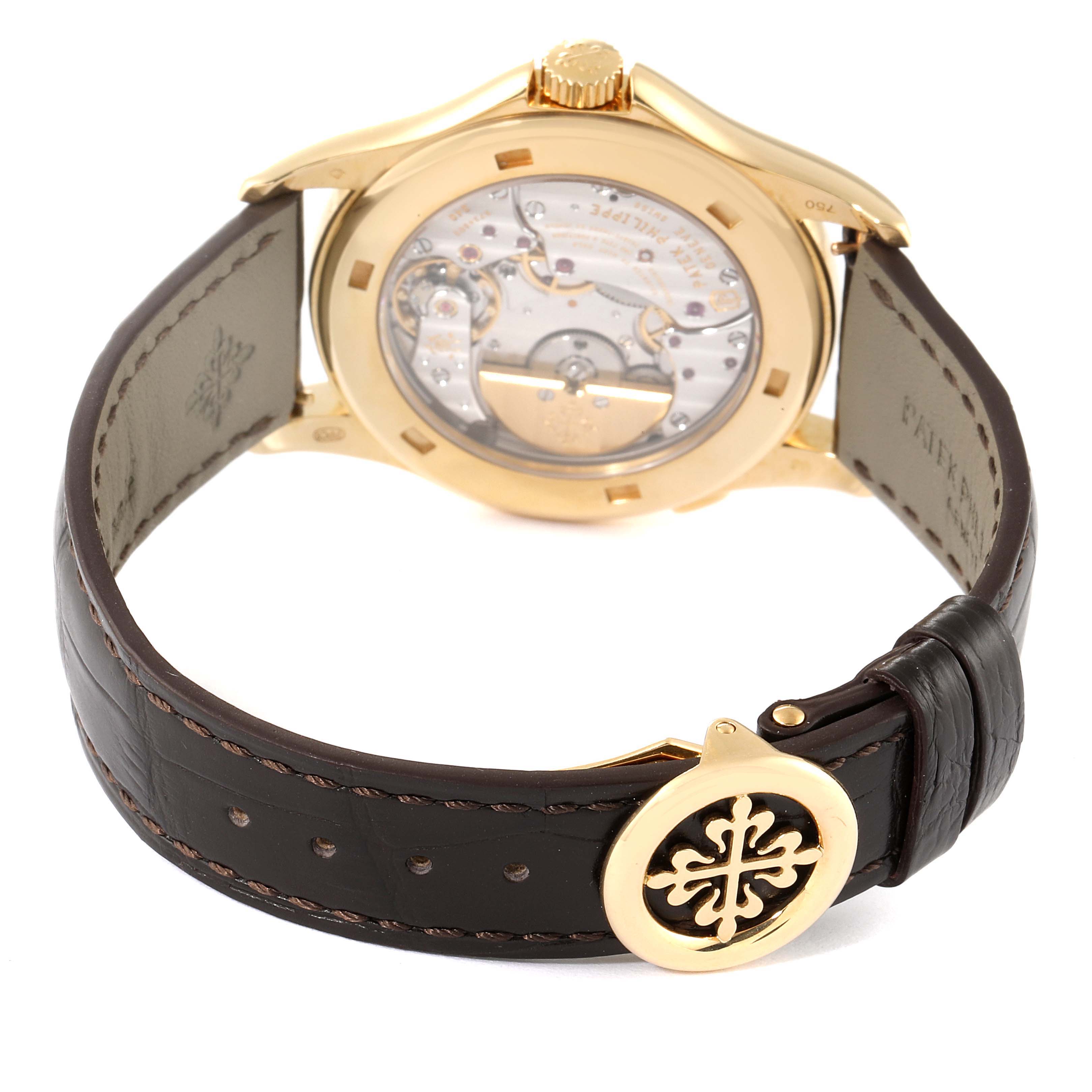 The image shows the back view of a Patek Philippe Complications 5130J Men's Yellow Gold Silver Dial 5130J Men's Yellow Gold Silver Dial watch, highlighting its transparent case back and leather strap with buckle.