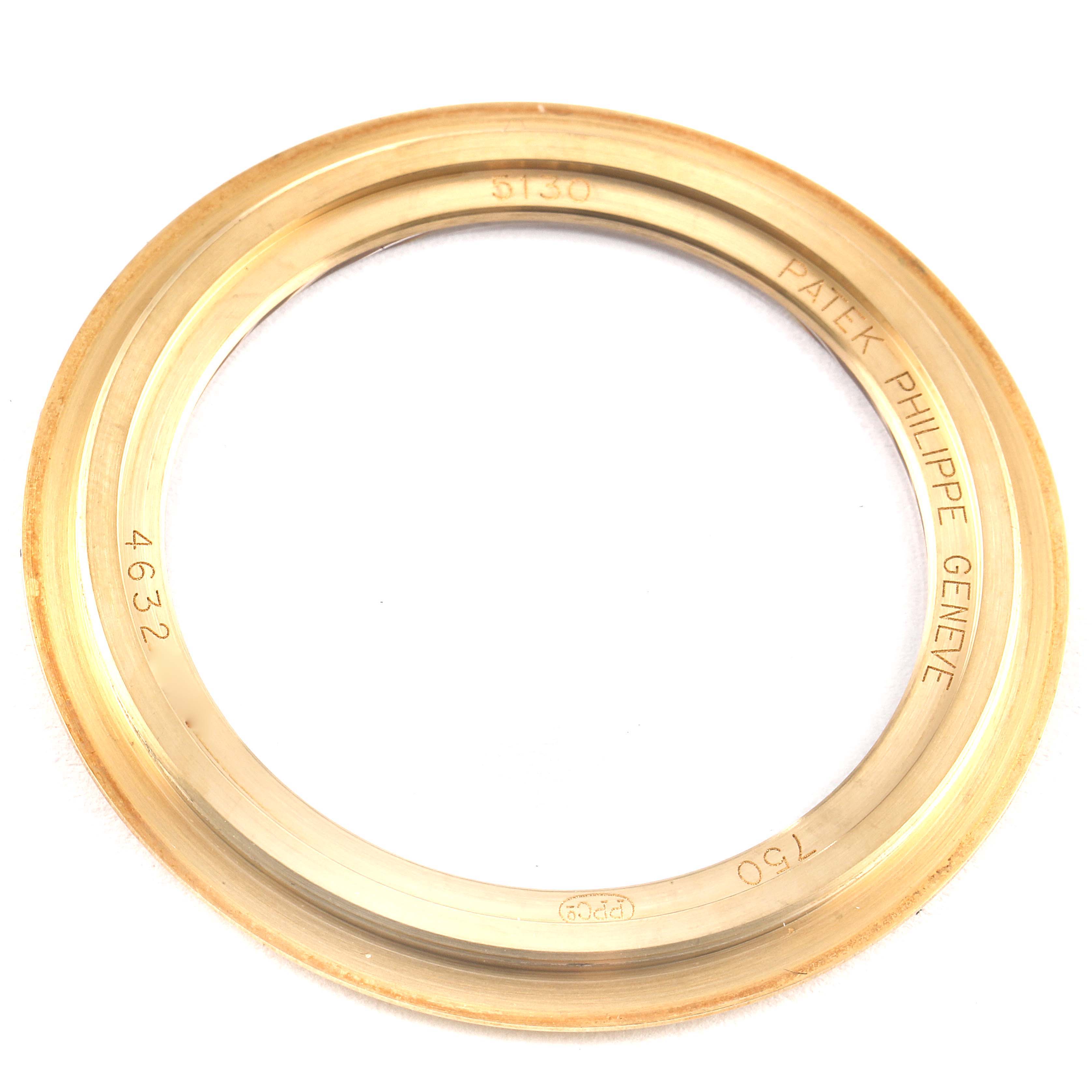 This image shows a gold bezel from a Patek Philippe Complications 5130J Men's Yellow Gold Silver Dial 5130J Men's Yellow Gold Silver Dial model, viewed from the top.