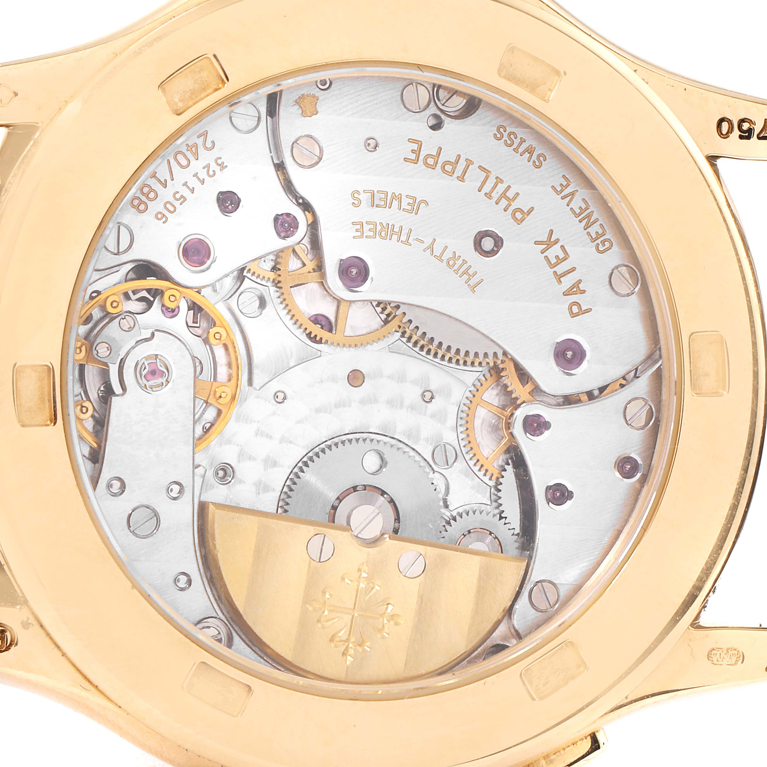 The image shows the back view of a Patek Philippe Complications 5110J Men's Yellow Gold Silver Dial 5110J Men's Yellow Gold Silver Dial model, highlighting its intricate movement and gears.