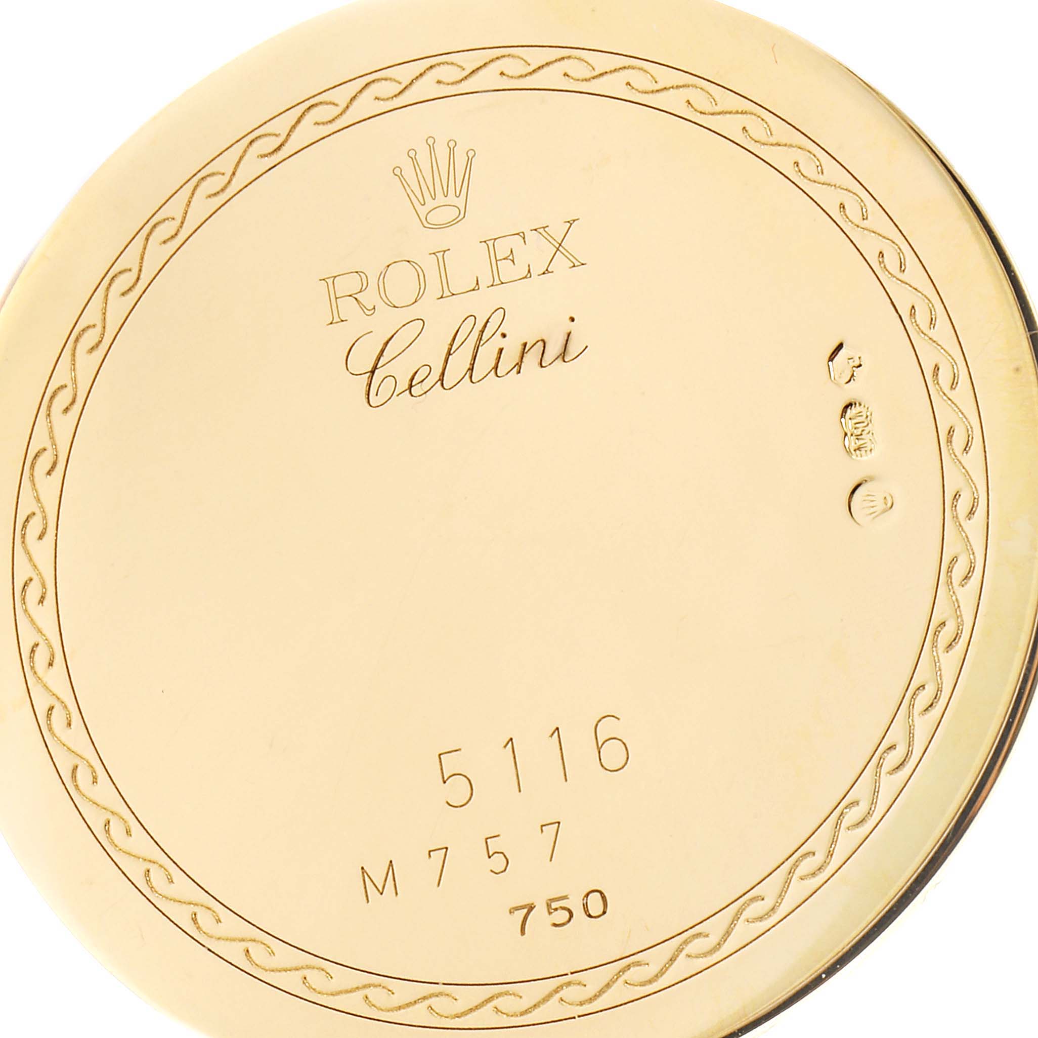 This image shows the back casing of the Rolex Cellini 5116 Men's Yellow Gold Champagne Dial 5116 Men's Yellow Gold Champagne Dial watch, featuring engravings and hallmarks.