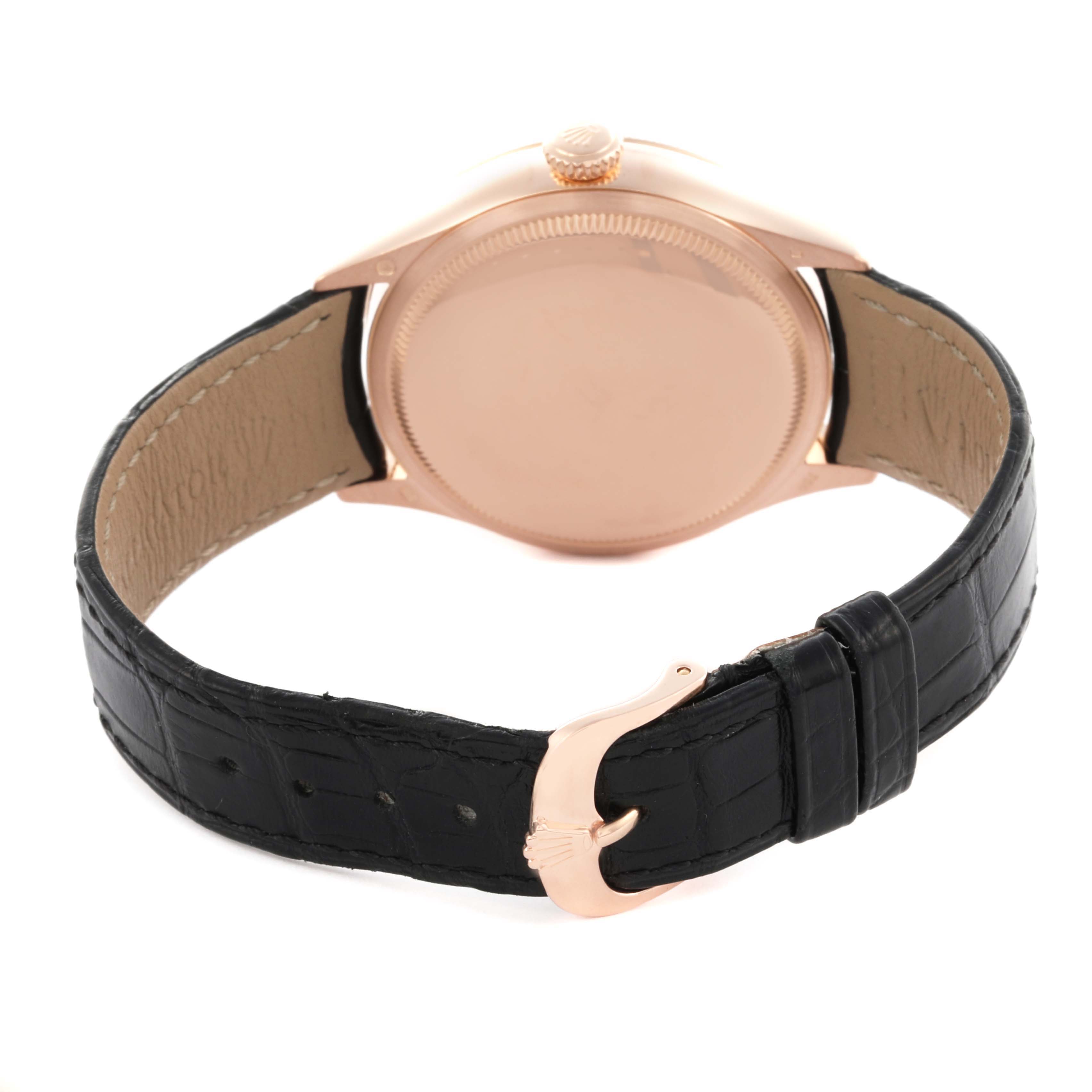 The Rolex Cellini 50515 Men's Rose Gold Silver Dial 50515 Men's Rose Gold Silver Dial watch is shown from the rear, highlighting its case back, crown, and black leather strap with a clasp.