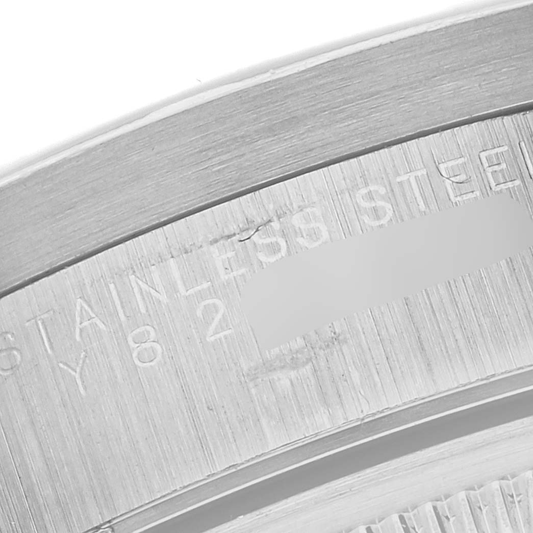 The image shows a close-up angle of the case back of a Rolex Date 15210 Men's Stainless Steel Black Dial 15210 Men's Stainless Steel Black Dial model, highlighting the stainless steel material.