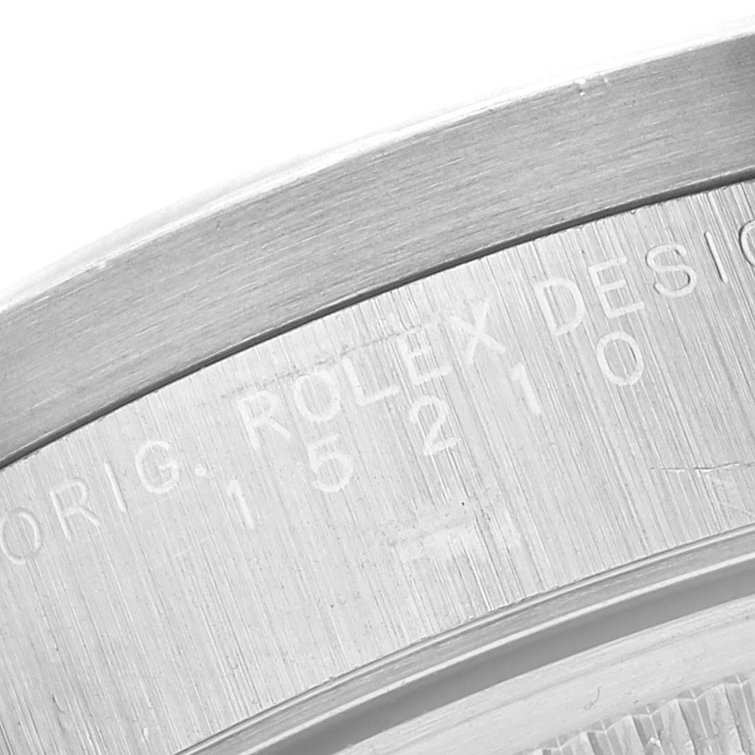This image shows a close-up of the case back of a Rolex Date 15210 Men's Stainless Steel Black Dial 15210 Men's Stainless Steel Black Dial model, focusing on the engraved text and design number.