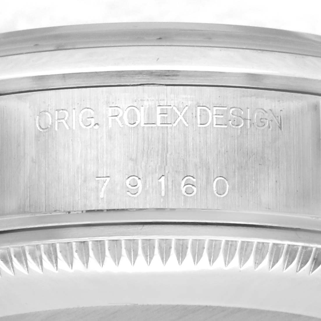 The image shows the side view of the bezel and the engraved case side of a Rolex Date 79160 Women's Stainless Steel Black Dial 79160 Women's Stainless Steel Black Dial model, displaying "ORIG. ROLEX DESIGN" and "79160."