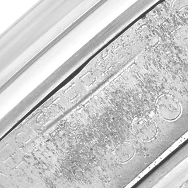 The image shows a close-up of the metal band and clasp, featuring engravings on the Vintage Collection model by Rolex.