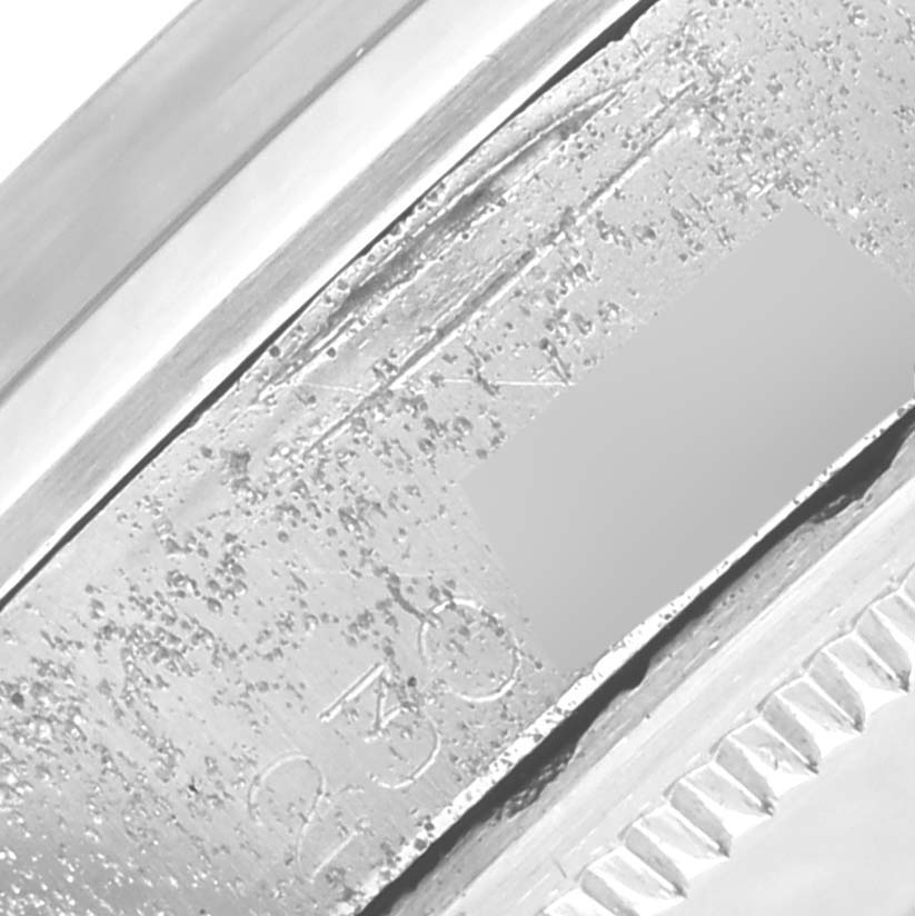 The image shows a close-up of the engraved details on the bezel and case of a Rolex Vintage Collection 1500 Men's Stainless Steel Silver Dial 1500 Men's Stainless Steel Silver Dial watch.