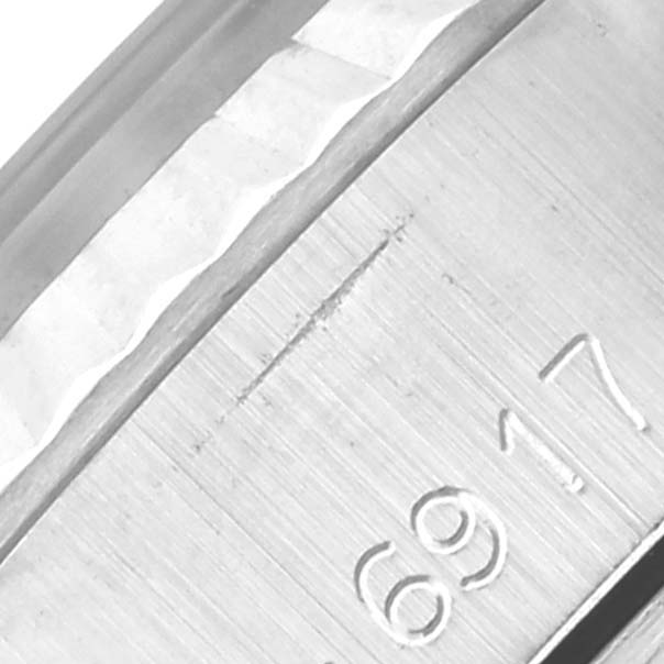 The image shows a close-up of the side of a Rolex Date 6917 Women's Stainless Steel Silver Dial 6917 Women's Stainless Steel Silver Dial model, highlighting the serial or model number engraving.