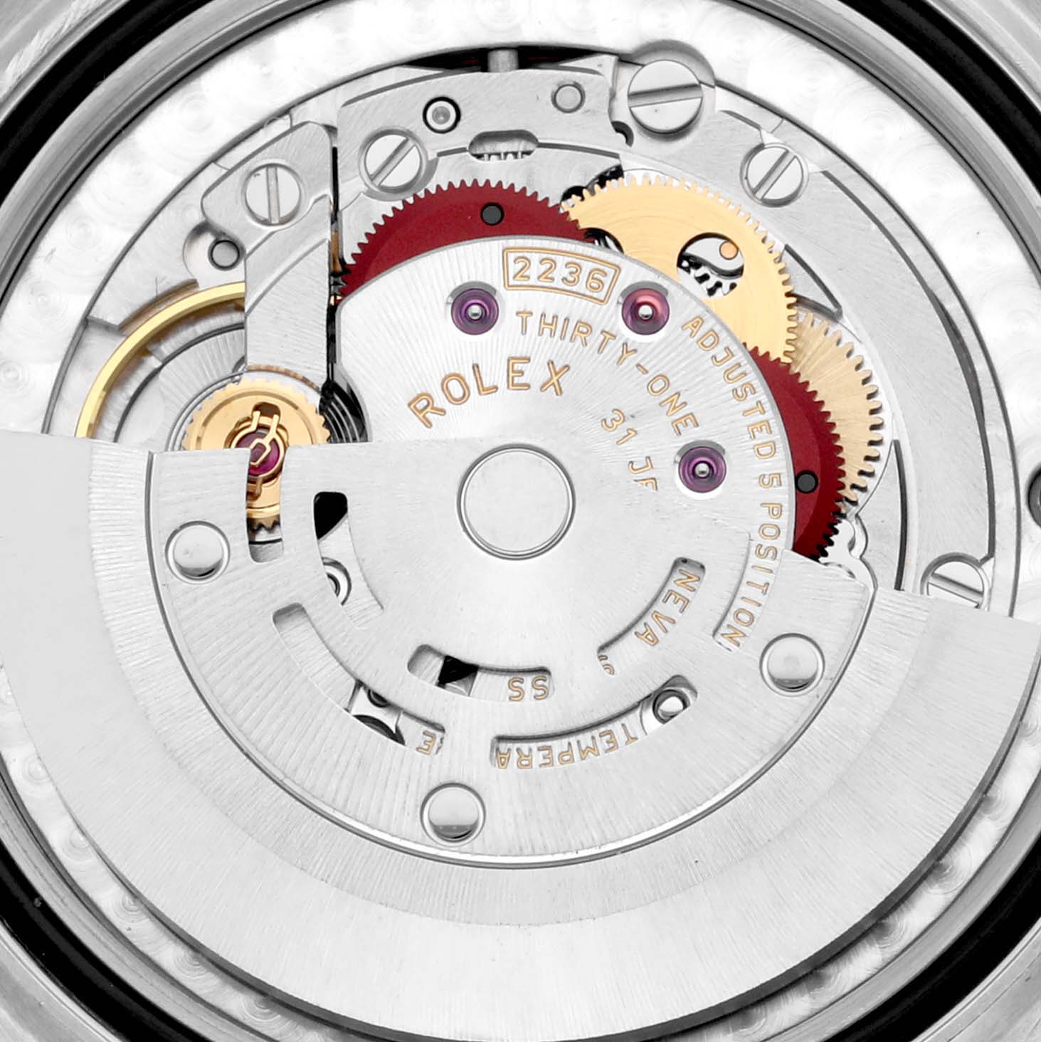 This image shows the internal mechanism of a Mid-Size Rolex watch from a top-down angle, highlighting gears and movements.