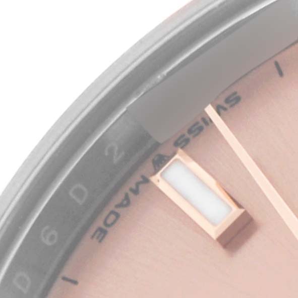 The image shows a close-up of the Rolex Mid-Size 278241 Women's Steel and Gold (two tone) Pink Dial 278241 Women's Steel and Gold (two tone) Pink Dial model watch face, highlighting the dial, part of the hour marker, and the "SWISS MADE" text.