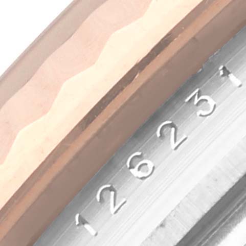 The image shows a close-up view of the Rolex Datejust 126231 Men's Steel and Gold (two tone) Grey Dial 126231 Men's Steel and Gold (two tone) Grey Dial's fluted bezel and part of the rehaut with engraved numbers.