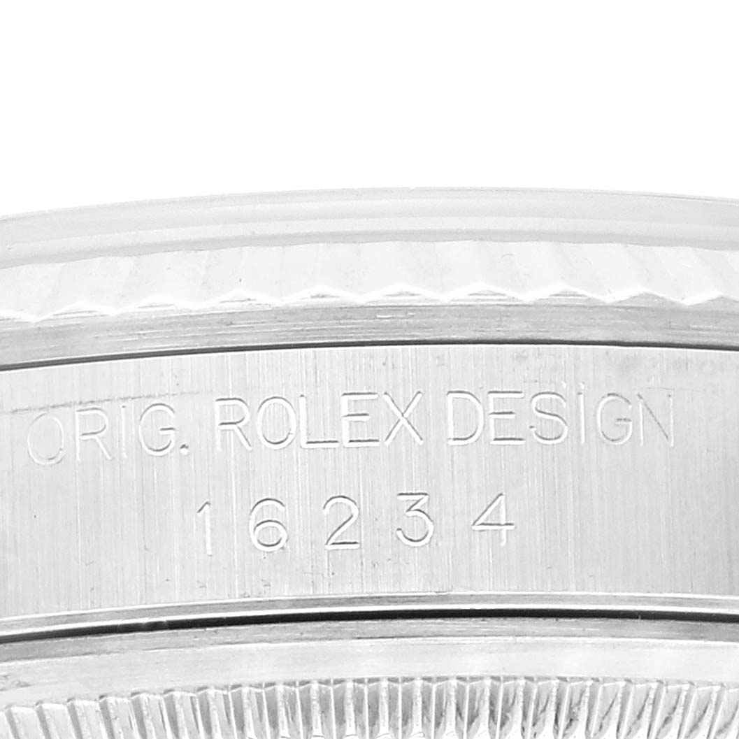 The image shows an engraving on the side of the case of a Rolex Datejust 16234 Men's Stainless Steel Blue Dial 16234 Men's Stainless Steel Blue Dial model, featuring its reference number, 16234.