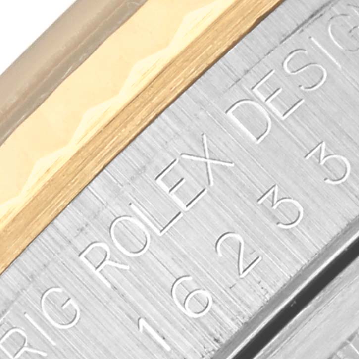 The image shows a close-up of the case side of a Rolex Datejust 16233 Men's Steel and Gold (two tone) Black Dial 16233 Men's Steel and Gold (two tone) Black Dial, highlighting the engraved reference number and edge of the bezel.