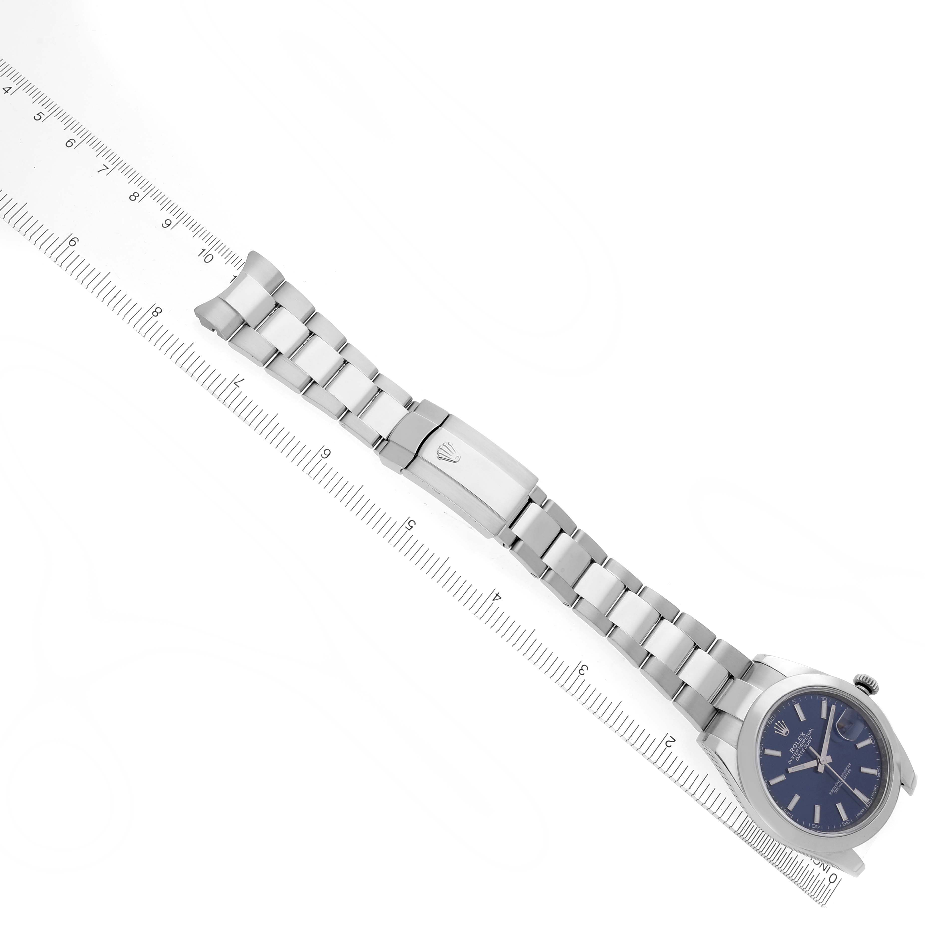 The Rolex Datejust 41 126300 Men's Stainless Steel Blue Dial 126300 Men's Stainless Steel Blue Dial is shown from an overhead angle, displaying the full bracelet and watch face alongside a ruler for scale.