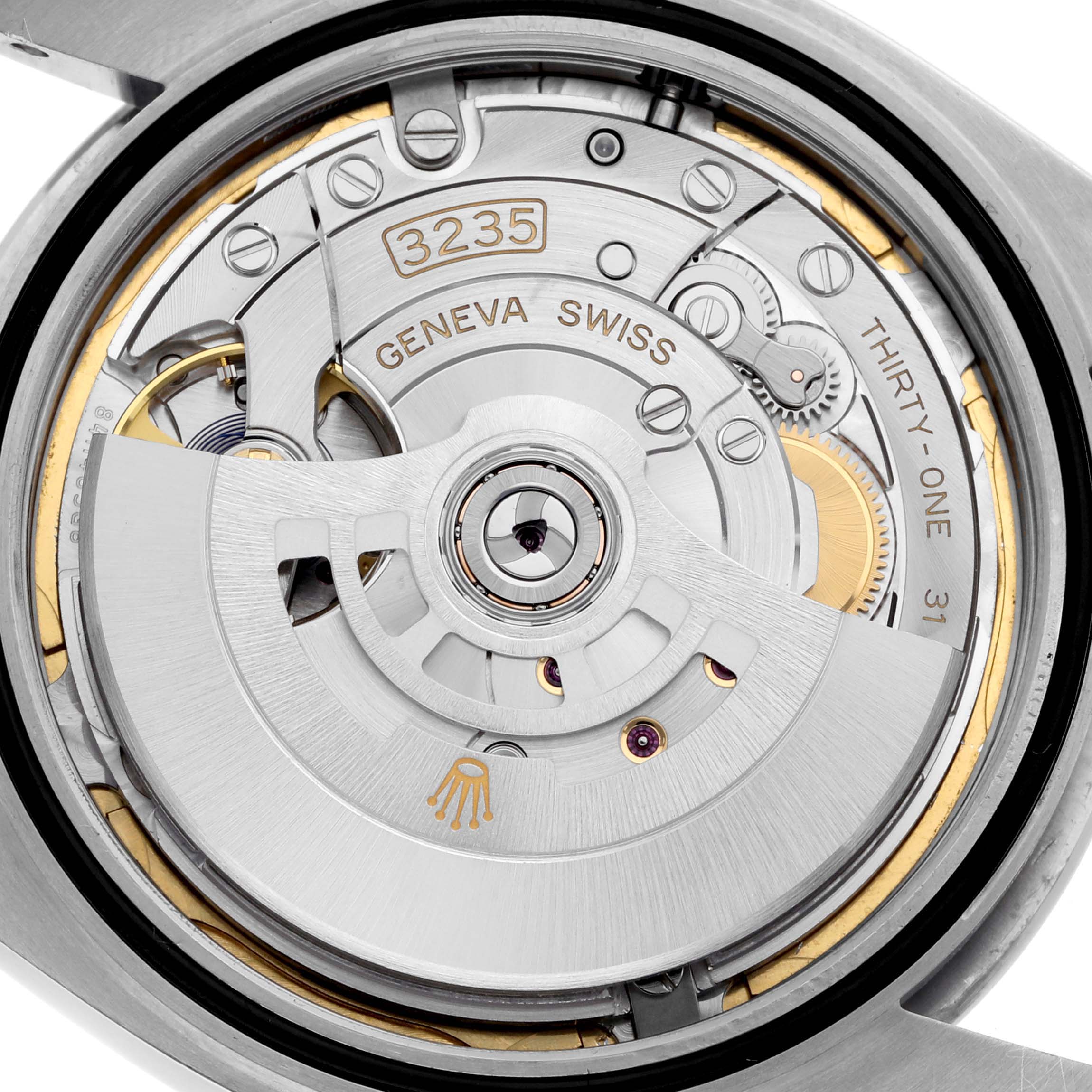 The image shows a close-up of the Rolex Datejust 41 126300 Men's Stainless Steel Blue Dial 126300 Men's Stainless Steel Blue Dial's internal movement from a rear angle, highlighting its rotor and mechanical elements.