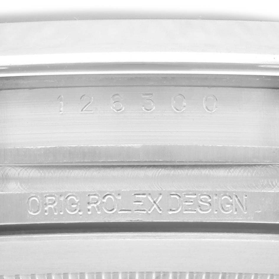 The image shows the engraved inner bezel of a Rolex Datejust 41 126300 Men's Stainless Steel Blue Dial 126300 Men's Stainless Steel Blue Dial, displaying the serial and model numbers.