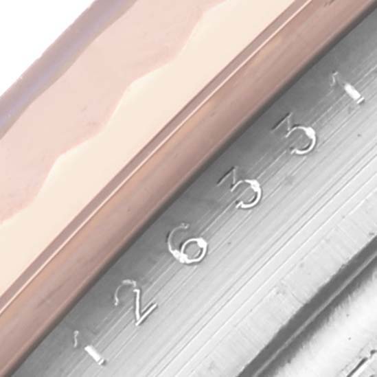 The image shows a close-up of the Rolex Datejust 41 126331 Men's Steel and Gold (two tone) Pink Dial 126331 Men's Steel and Gold (two tone) Pink Dial bezel and part of the fluted structure.