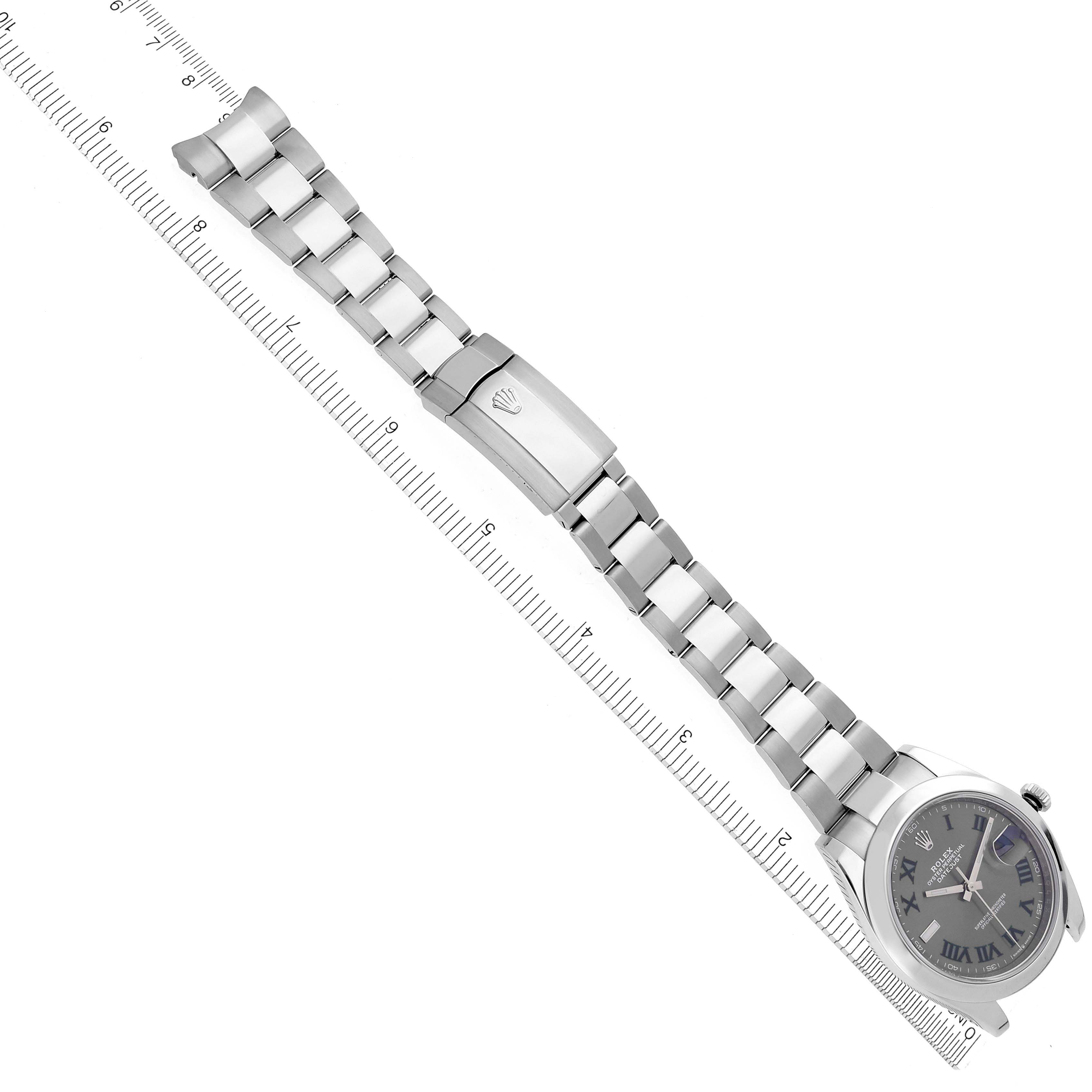 The Rolex Datejust 41 126300 Men's Stainless Steel Grey Dial 126300 Men's Stainless Steel Grey Dial watch is displayed from a top-down angle, showing the bracelet, clasp, and watch face alongside a ruler.
