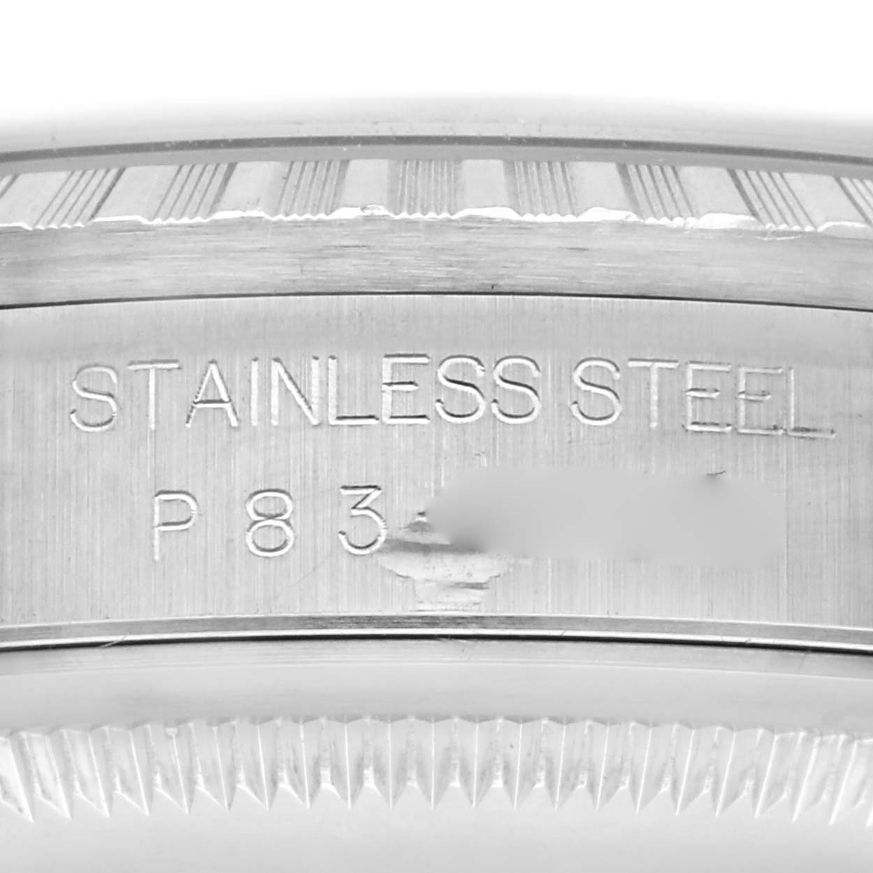 The image shows a close-up of the case's edge and bezel of a Rolex Datejust 16220 Men's Stainless Steel Black Dial 16220 Men's Stainless Steel Black Dial, highlighting "STAINLESS STEEL" engraving.
