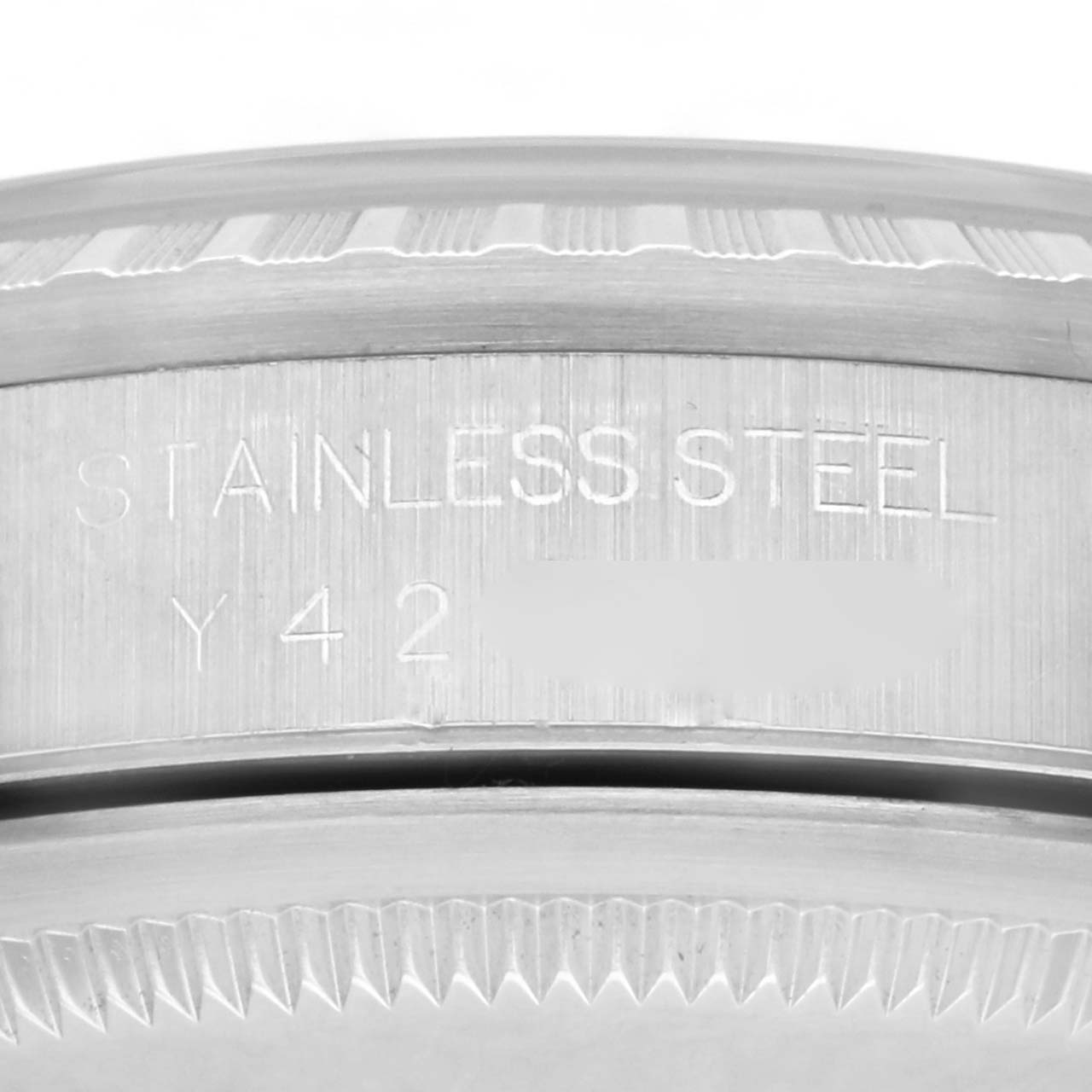 The image shows a close-up of the stainless steel case back and edge of the bezel of a Rolex Datejust 16220 Men's Stainless Steel Black Dial 16220 Men's Stainless Steel Black Dial watch.