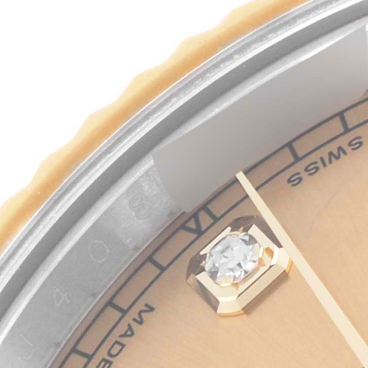 The image shows a close-up of the Rolex Datejust 41 116333 Men's Steel and Gold (two tone) Champagne Dial 116333 Men's Steel and Gold (two tone) Champagne Dial's dial and diamond marker, taken at an angle highlighting the bezel.