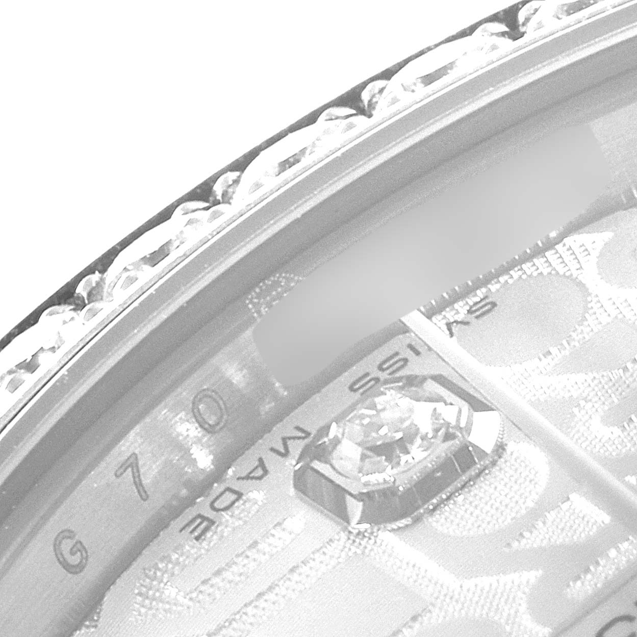 The close-up image of the Rolex Mid-Size 178384 Women
s Stainless Steel Silver Dial 178384 Women
s Stainless Steel Silver Dial watch shows a section of the bejeweled bezel and part of the dial with "Swiss Made" text.