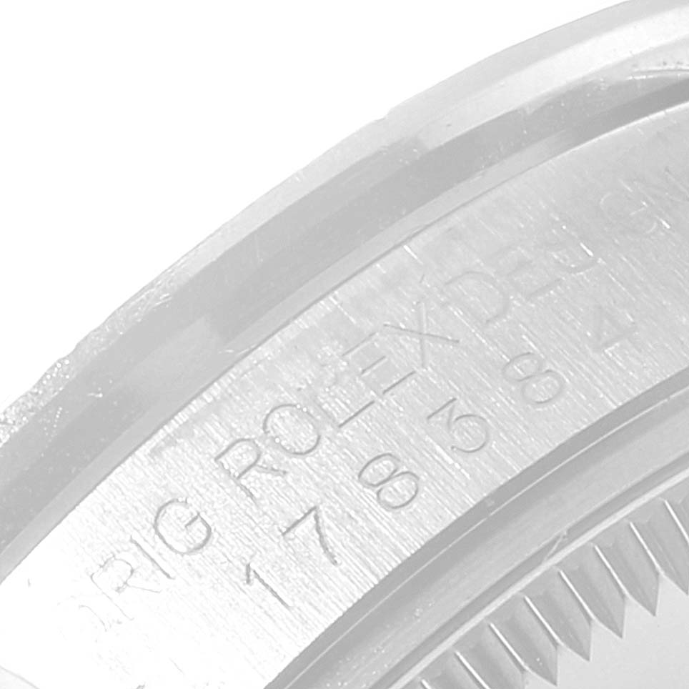 The image shows a close-up angle of the case back with engravings of a Rolex Mid-Size 178384 Women
s Stainless Steel Silver Dial 178384 Women
s Stainless Steel Silver Dial model watch.