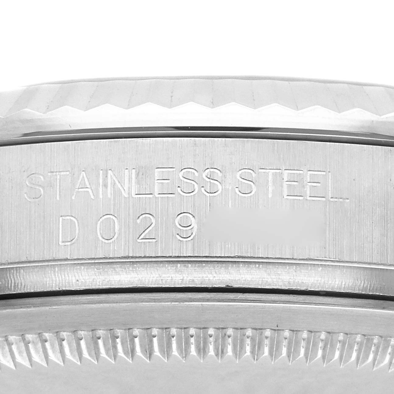 The image shows a close-up of the casing side of a Rolex Datejust 116234 Men's Stainless Steel Blue Dial 116234 Men's Stainless Steel Blue Dial with "Stainless Steel" and a partial serial number engraved.