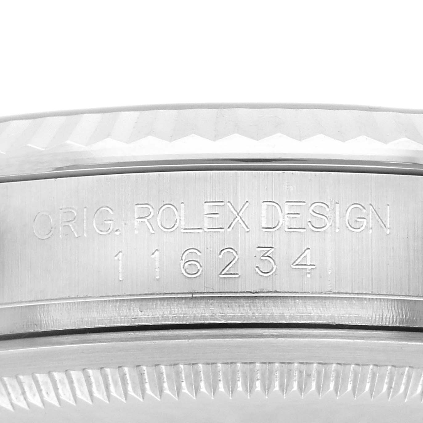 The image shows a close-up of the Rolex Datejust 116234 Men's Stainless Steel Blue Dial 116234 Men's Stainless Steel Blue Dial's engraving on the case, focusing on the model number and part of the bezel.