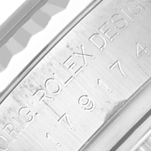 The image shows the side view of a Rolex Datejust 179174 Women's Stainless Steel Mother of Pearl Dial 179174 Women's Stainless Steel Mother of Pearl Dial case with engraved text, highlighting the design details.