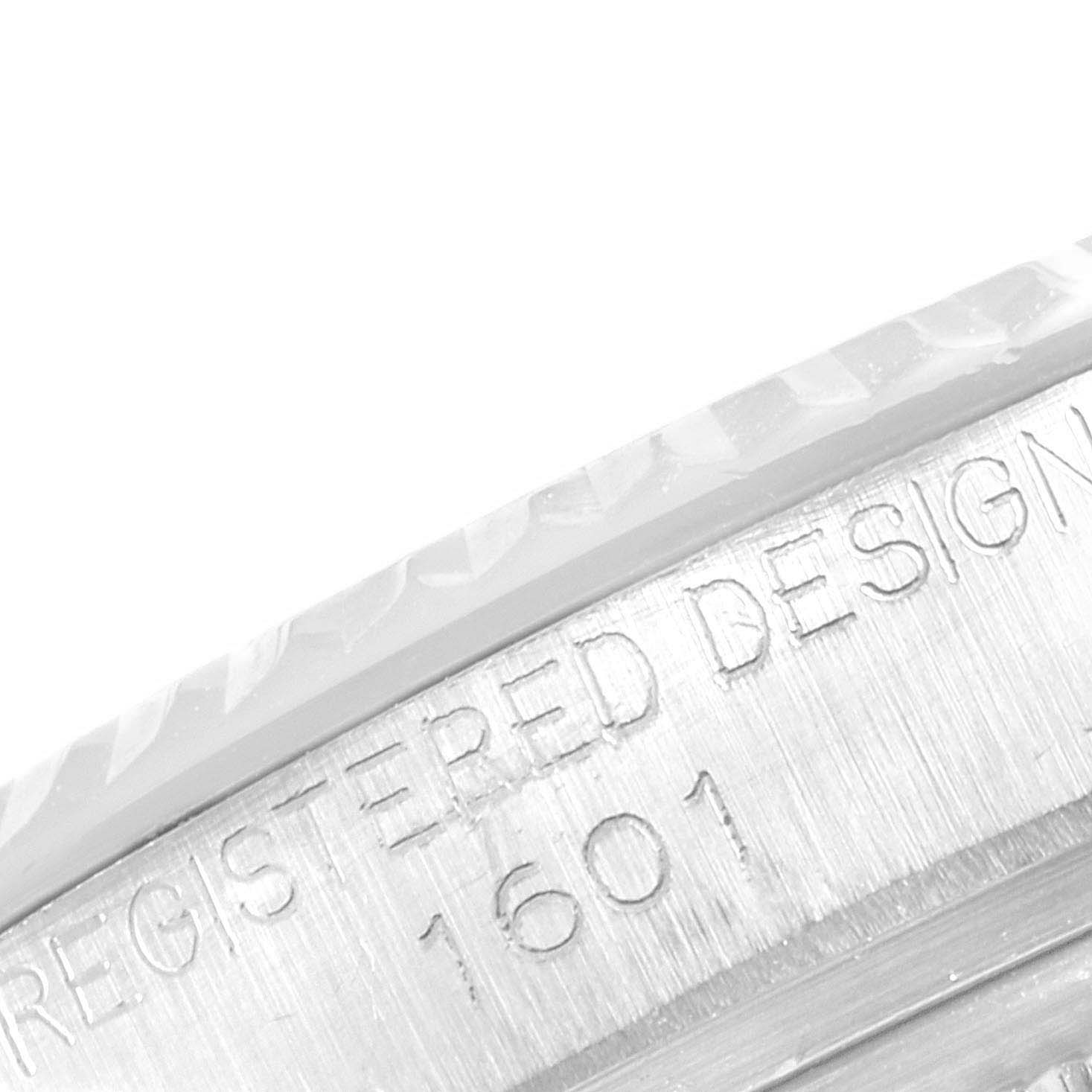 The image shows a close-up of the serial number engraving, "1601," on the edge of a Rolex Vintage Collection 1601 Men
s Stainless Steel Silver Dial 1601 Men
s Stainless Steel Silver Dial watch case.