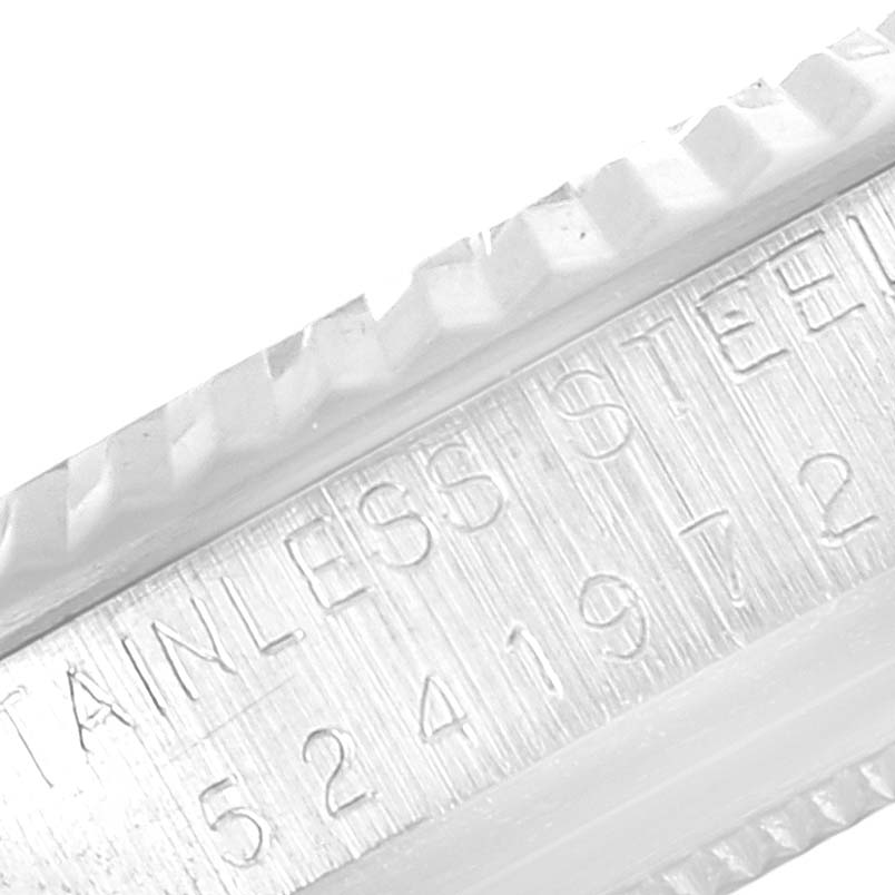 This is a close-up angle showing the engraved serial number and "STAINLESS STEEL" text on the side of a Rolex Vintage Collection 1601 Men
s Stainless Steel Silver Dial 1601 Men
s Stainless Steel Silver Dial watch case.