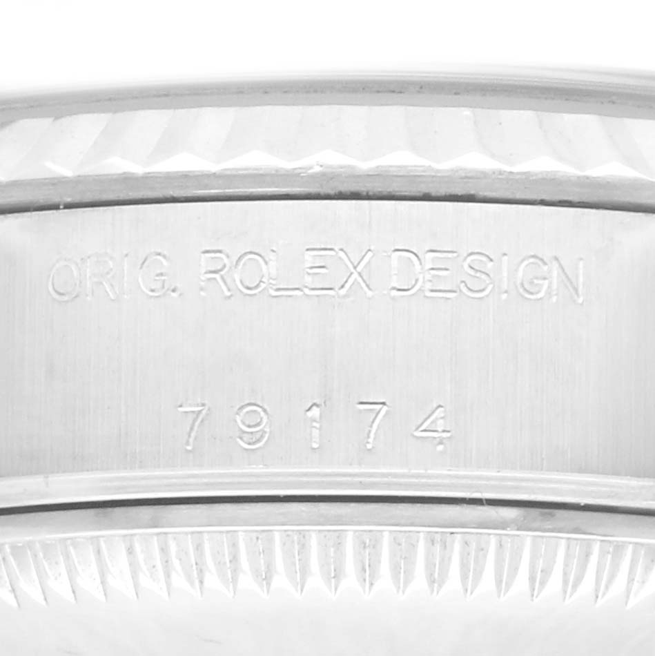 The image shows a close-up of the case side of a Rolex Datejust 79174 Women's Stainless Steel Silver Dial 79174 Women's Stainless Steel Silver Dial, displaying the model number and "ORIG. ROLEX DESIGN" engraving.
