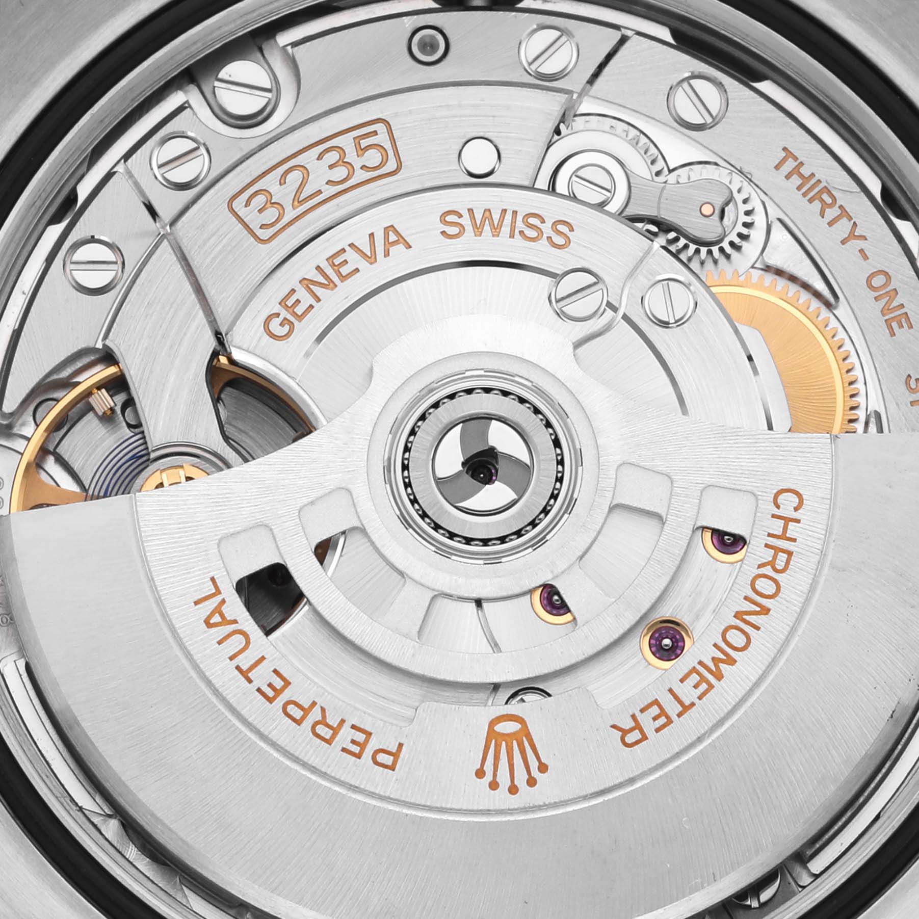 The image shows the movement of a Rolex Datejust 126234 Men's Stainless Steel Grey Dial 126234 Men's Stainless Steel Grey Dial, focusing on the 3235 caliber, gears, and inscriptions in close-up detail.