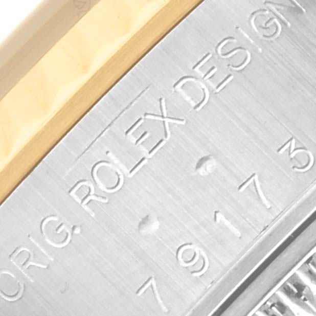 This image shows a detailed view of the engraving on the case side of a Rolex Datejust 79173 Women's Steel and Gold (two tone) Blue Dial 79173 Women's Steel and Gold (two tone) Blue Dial watch.