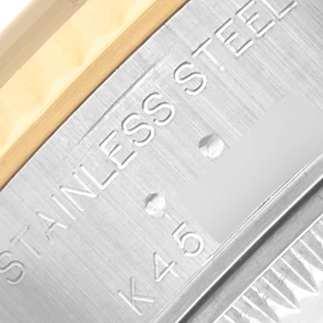 The image shows a close-up of the side of a Rolex Datejust 79173 Women's Steel and Gold (two tone) Blue Dial 79173 Women's Steel and Gold (two tone) Blue Dial, highlighting the stainless steel case with some engraved markings.