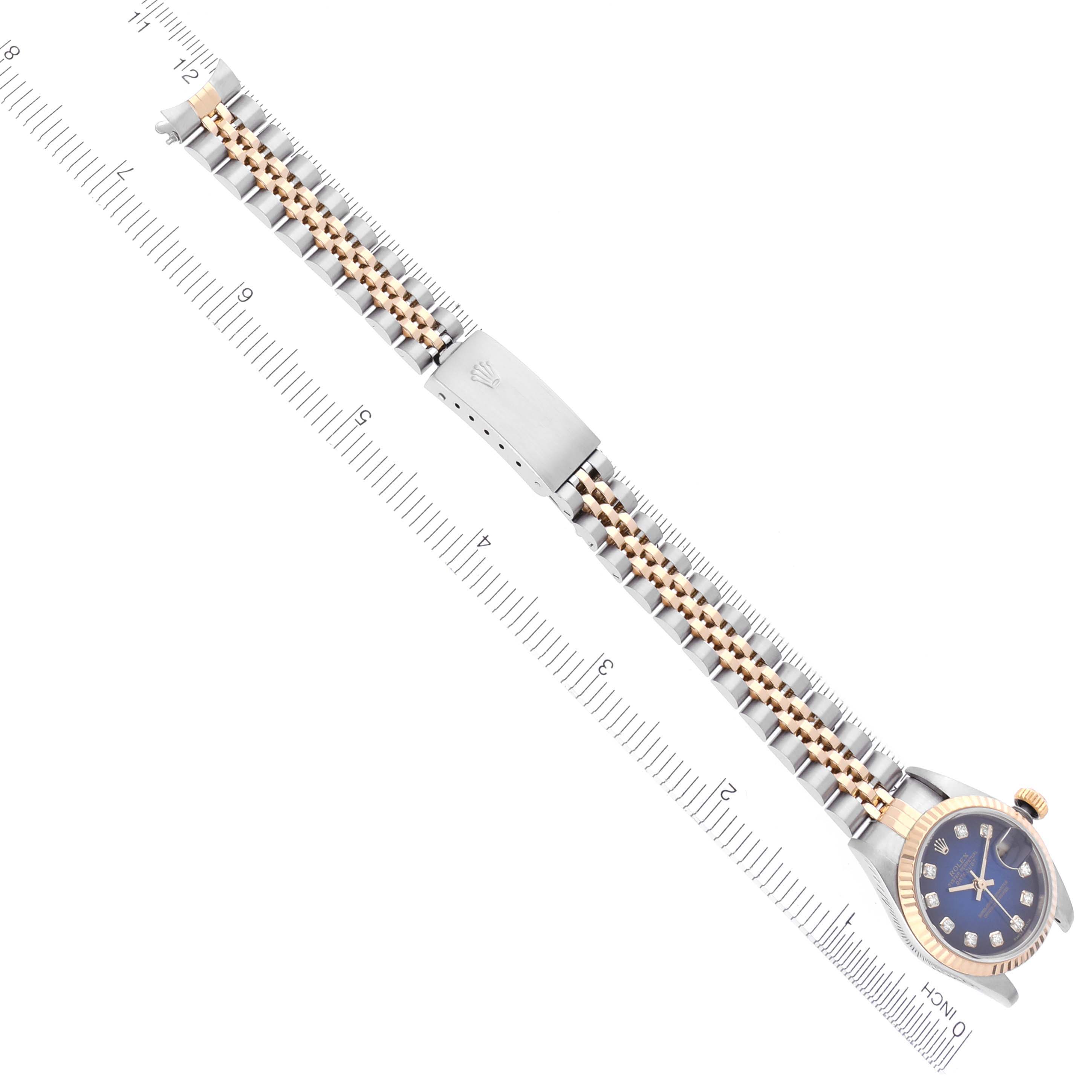 The Rolex Datejust 79173 Women's Steel and Gold (two tone) Blue Dial 79173 Women's Steel and Gold (two tone) Blue Dial watch is shown from a top-down angle, featuring the face and entire bracelet with a measuring ruler beside it.