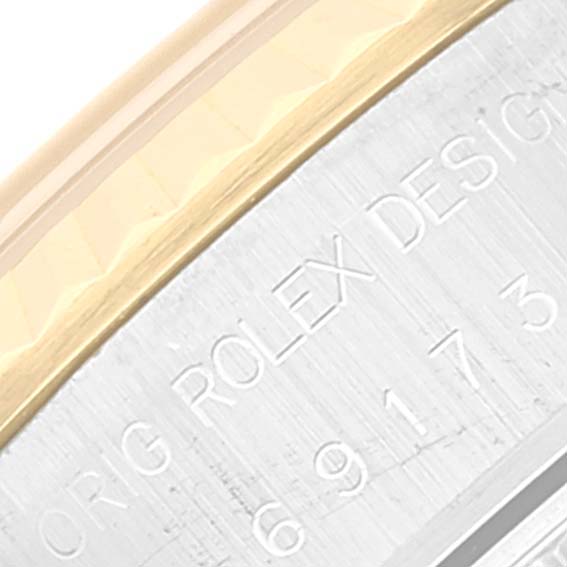 This close-up image shows the side engraving and the edge of the bezel of a Rolex Datejust 69173 Women's Steel and Gold (two tone) Champagne Dial 69173 Women's Steel and Gold (two tone) Champagne Dial watch.